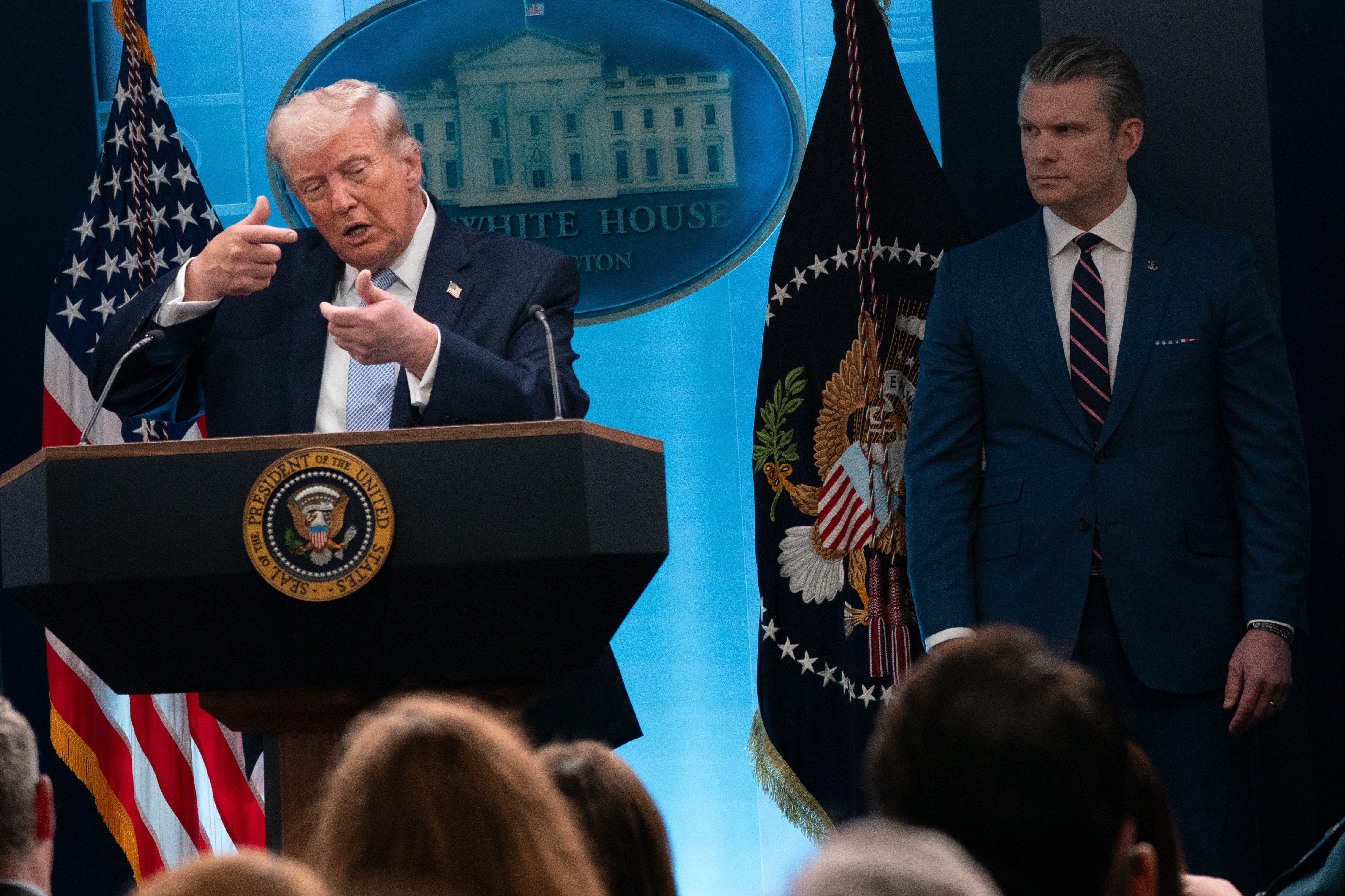 President Donald Trump with Defense Secretary Pete Hegseth at a news briefing April 6. (Maxine Wallace/The Washington Post)