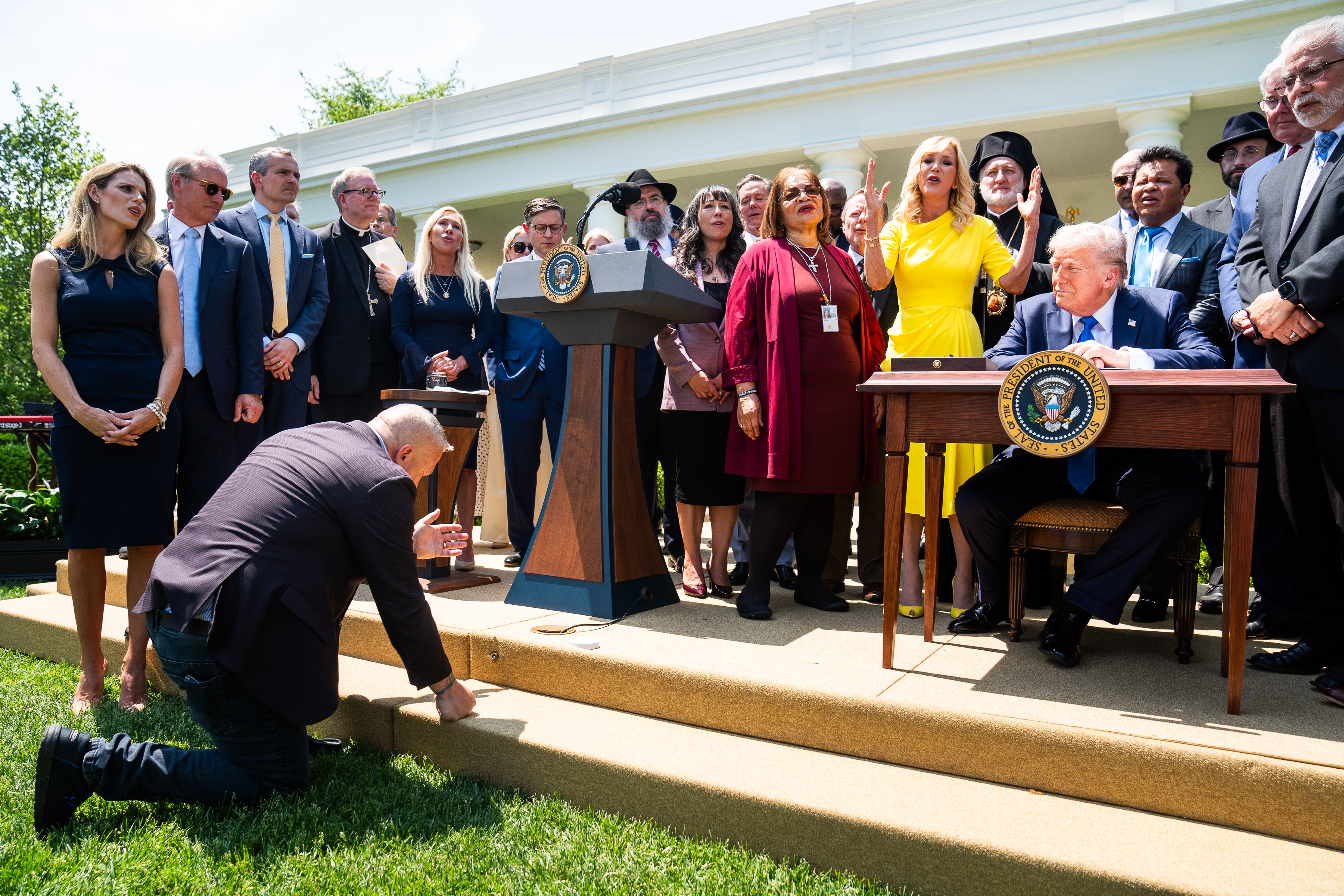 President Donald Trump prepares to sign an executive order after a prayer and song during a National Day of Prayer event in the Rose Garden in May. (Demetrius Freeman/The Washington Post)