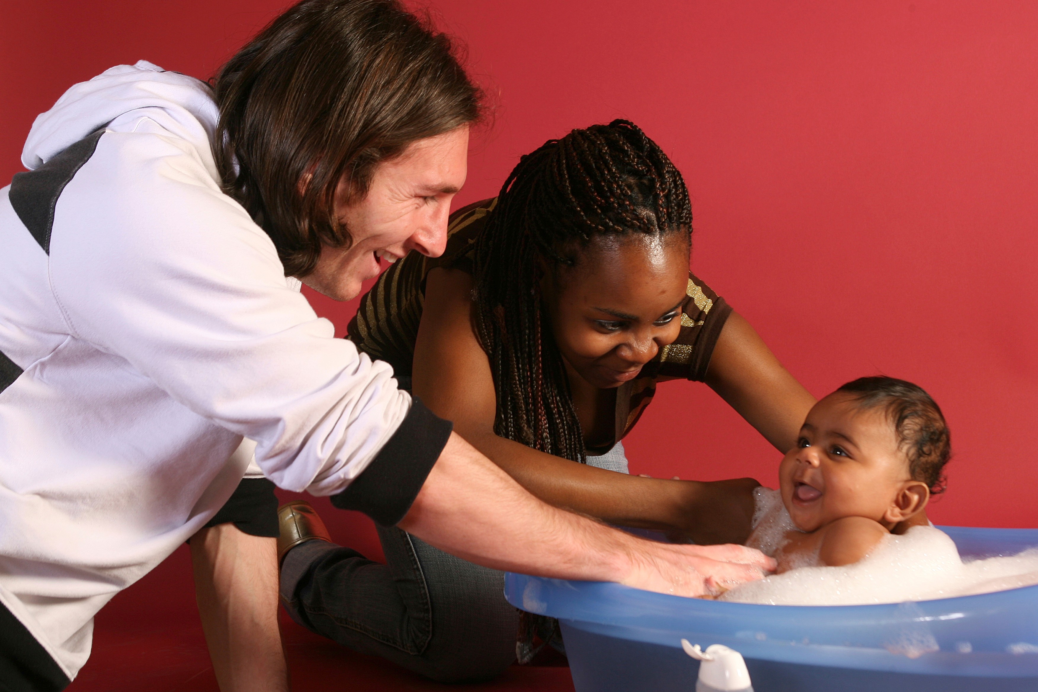 In this photo from 2007, 20-year-old soccer star Lionel Messi helps to bathe six-month-old Lamine Yamal, with Yamal's mother Sheila Ebana. (Joan Monfort/AP)