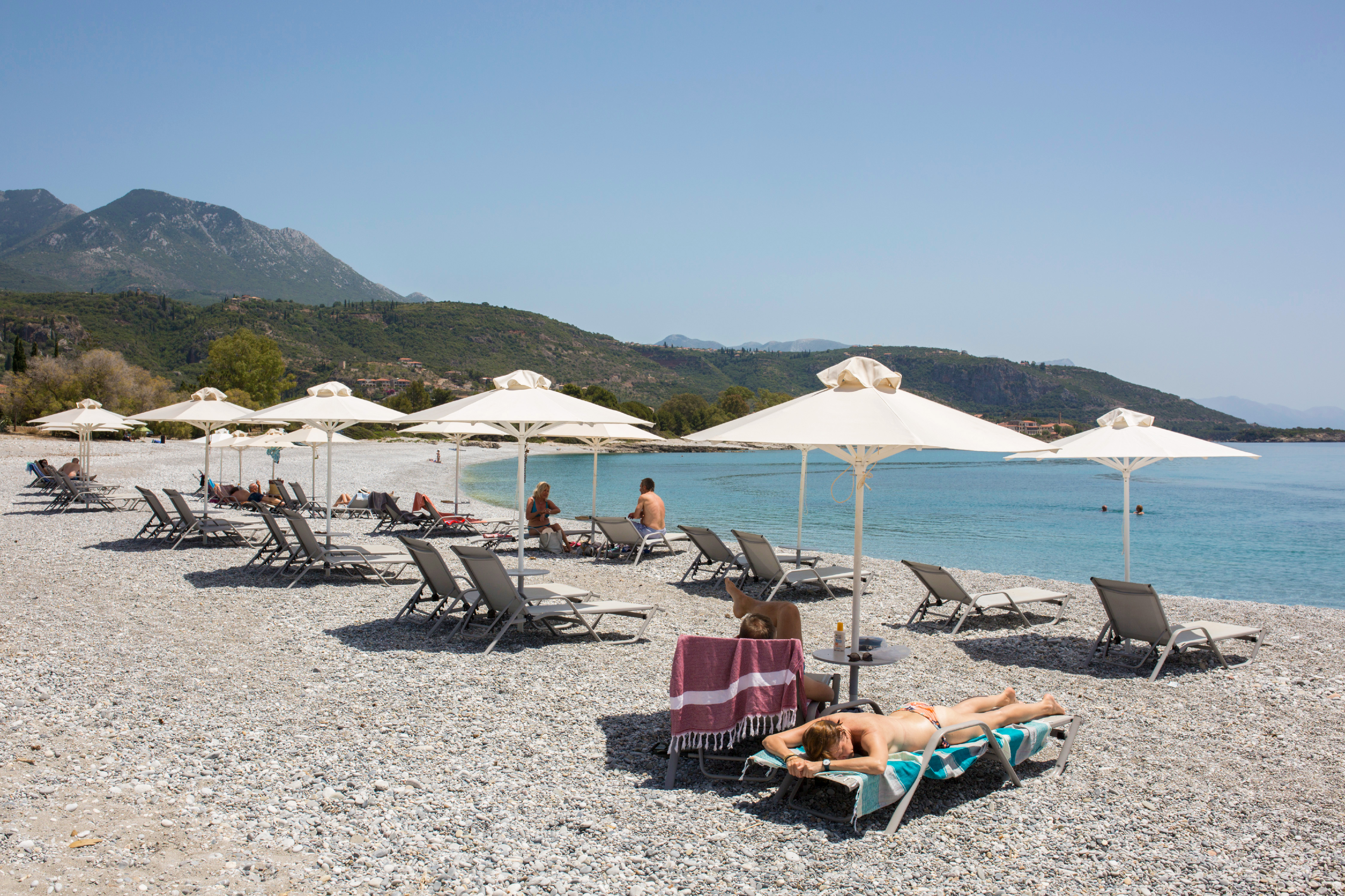 Soaking up the sun at Ritsa beach in Kardamyli, Greece. (Socrates Baltagiannis/Getty Images)