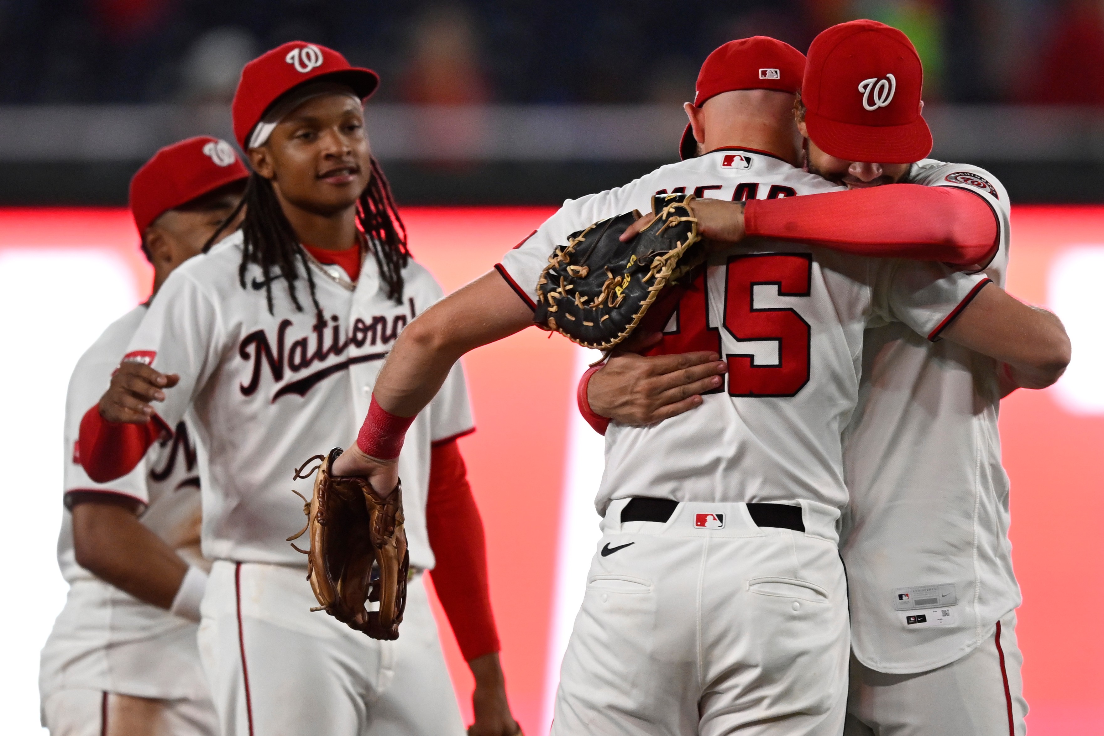 Curtis Mead, second from right, is congratulated by teammates Luis García Jr., right, and CJ Abrams, front left, after the Nationals defeat the visiting Phillies. (John McDonnell/AP Photo/John McDonnell)