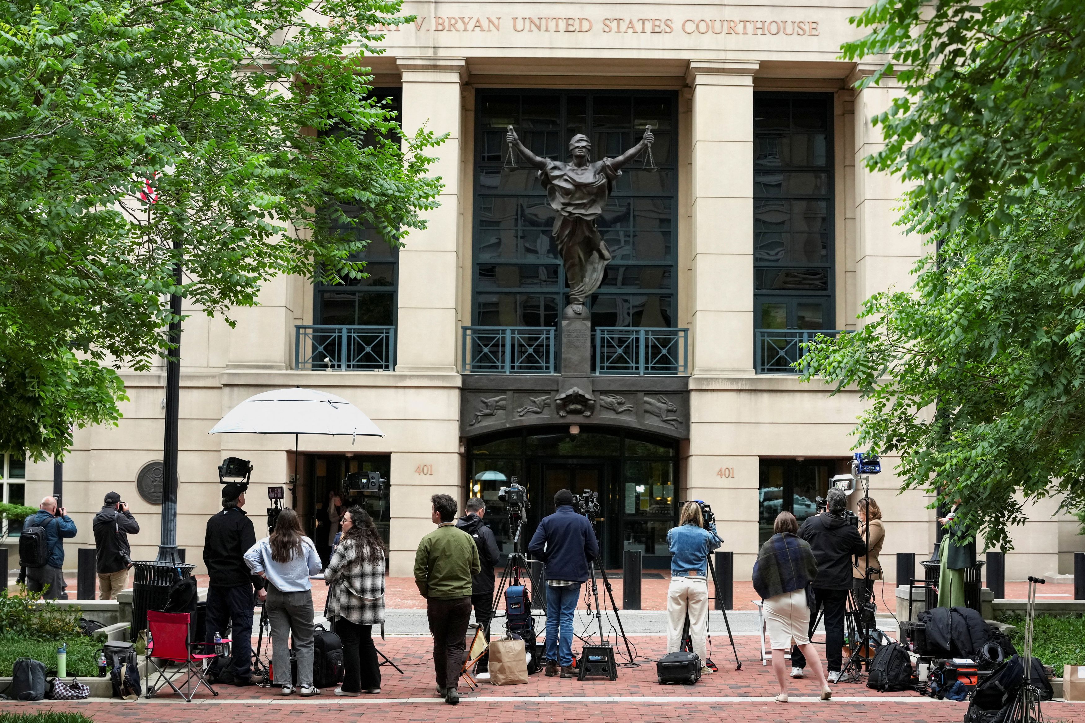 Members of the media wait outside a courthouse in Alexandria, Virginia, on Wednesday after a second indictment was announced against former FBI director James B. Comey. (Ken Cedeno/Reuters)