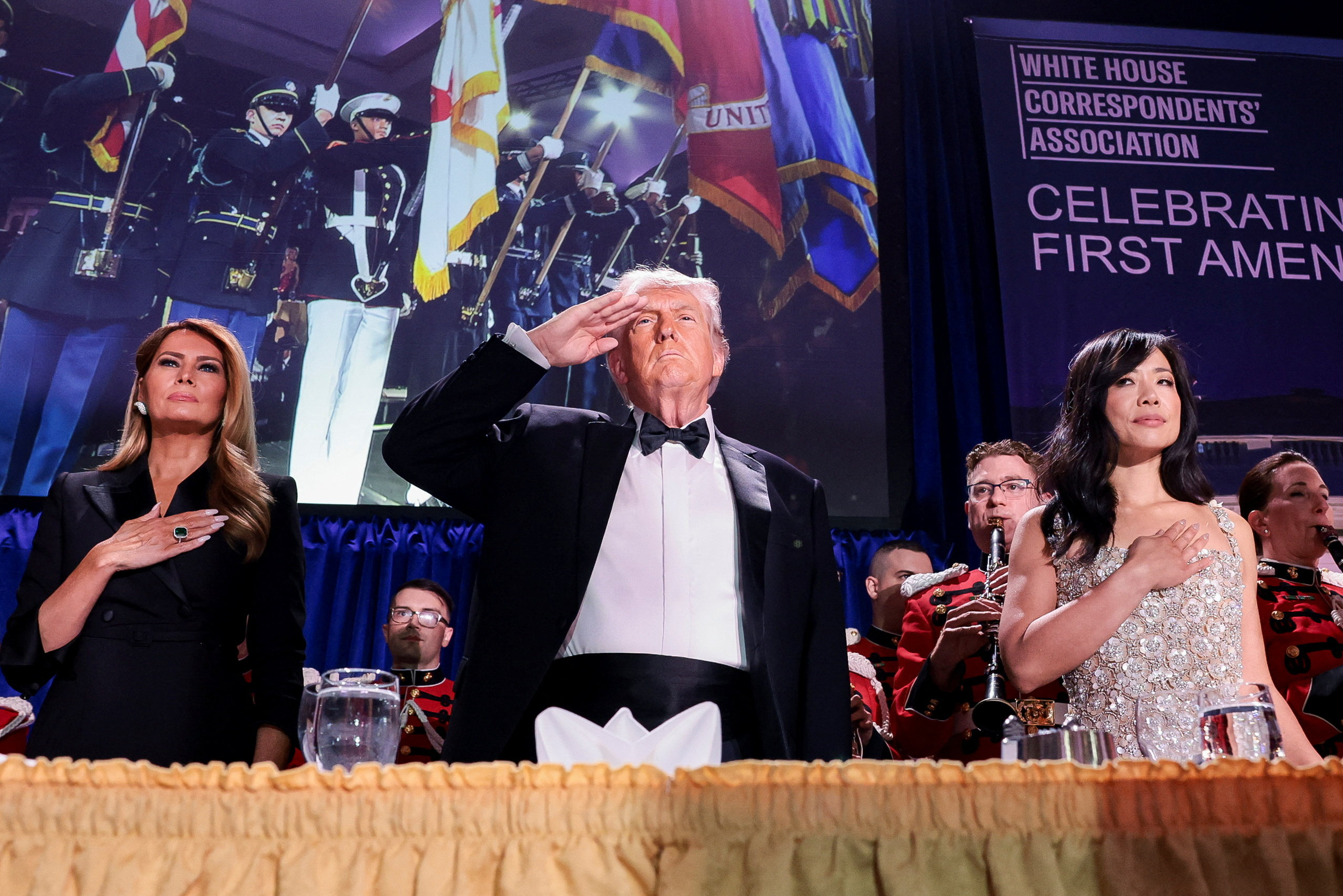 President Donald Trump with first lady Melania Trump and Weijia Jiang, president of the White House Correspondents' Association, minutes before gunfire disrupted the event. (Jonathan Ernst/Reuters)