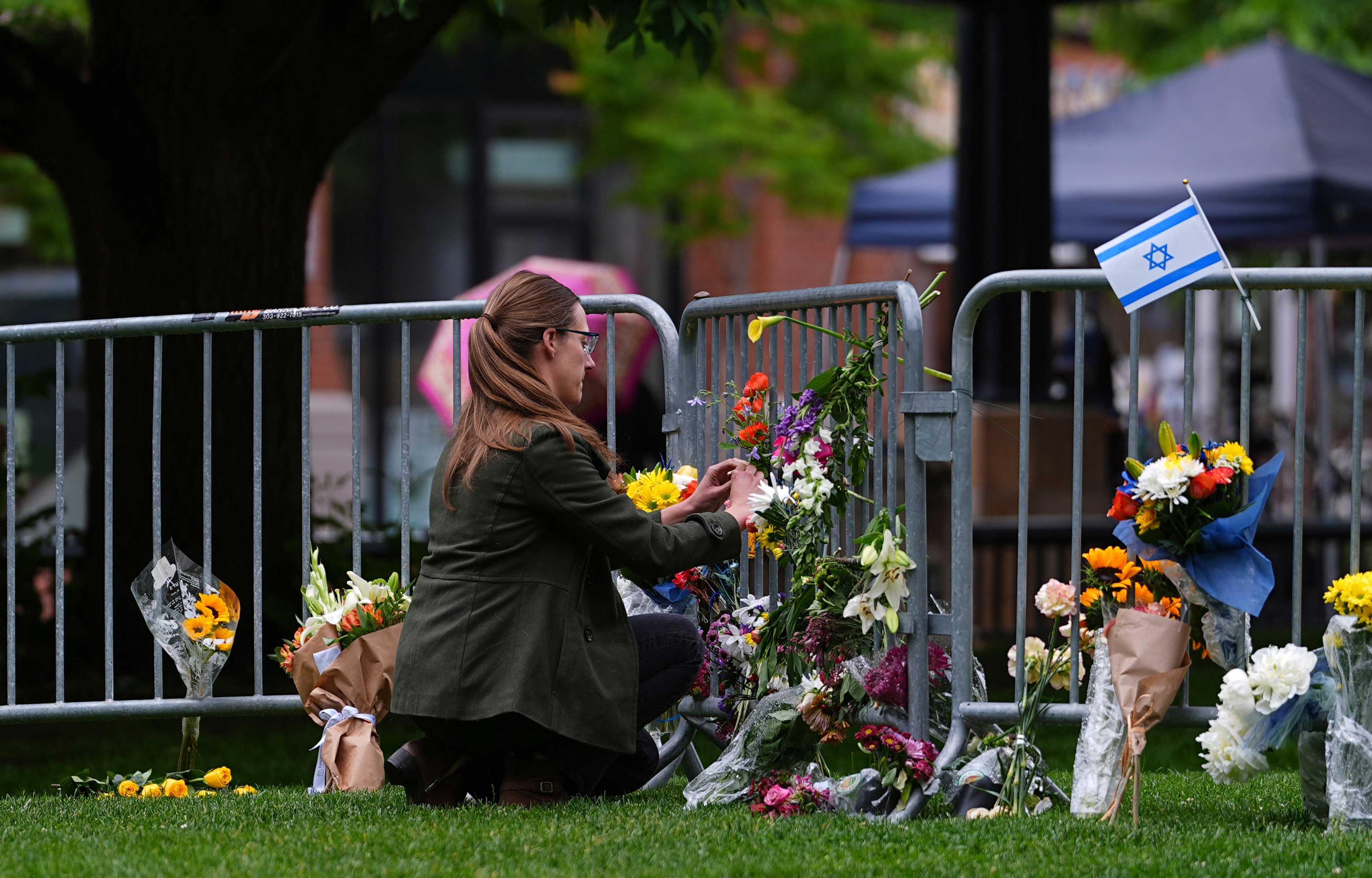 A woman places flowers at a makeshift memorial for victims of an attack outside a courthouse in Boulder, Colorado, on June 3. (David Zalubowski/AP)