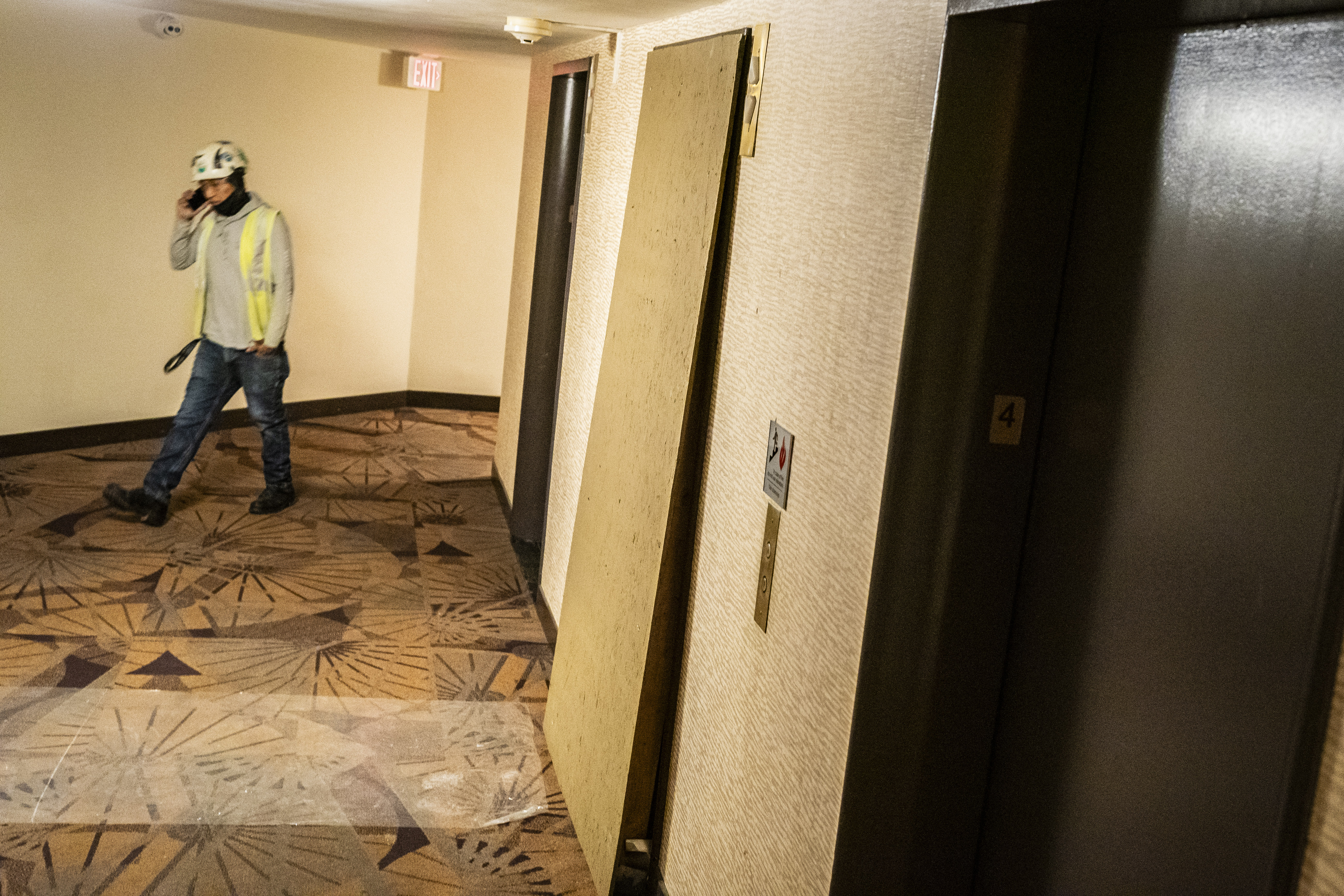 A cordoned-off elevator is seen covered by wood at Dorchester House. (Jabin Botsford/The Washington Post)
