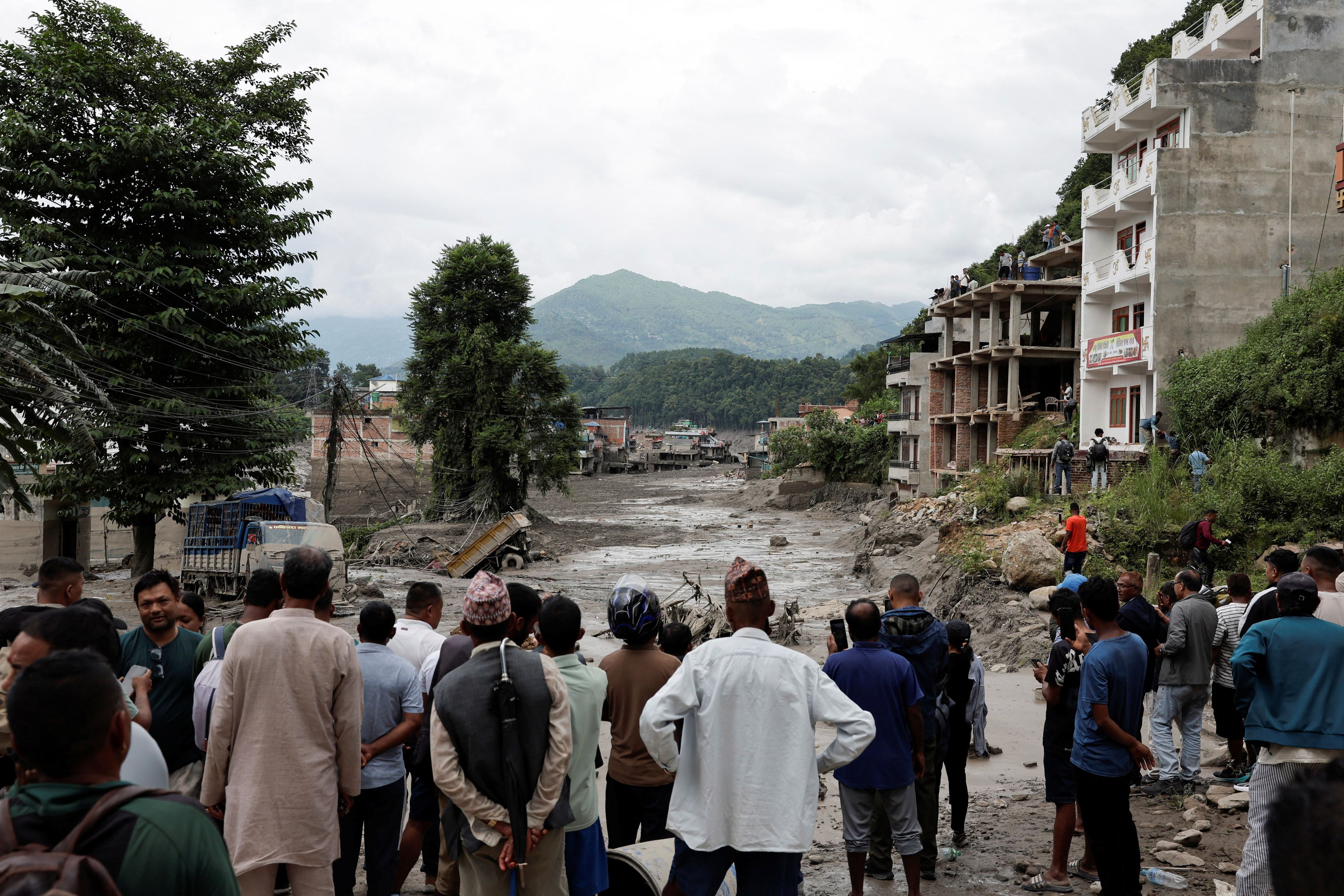 Flash floods on Nepal-China border kill at least 75, leave hundreds missing as rescue efforts continue