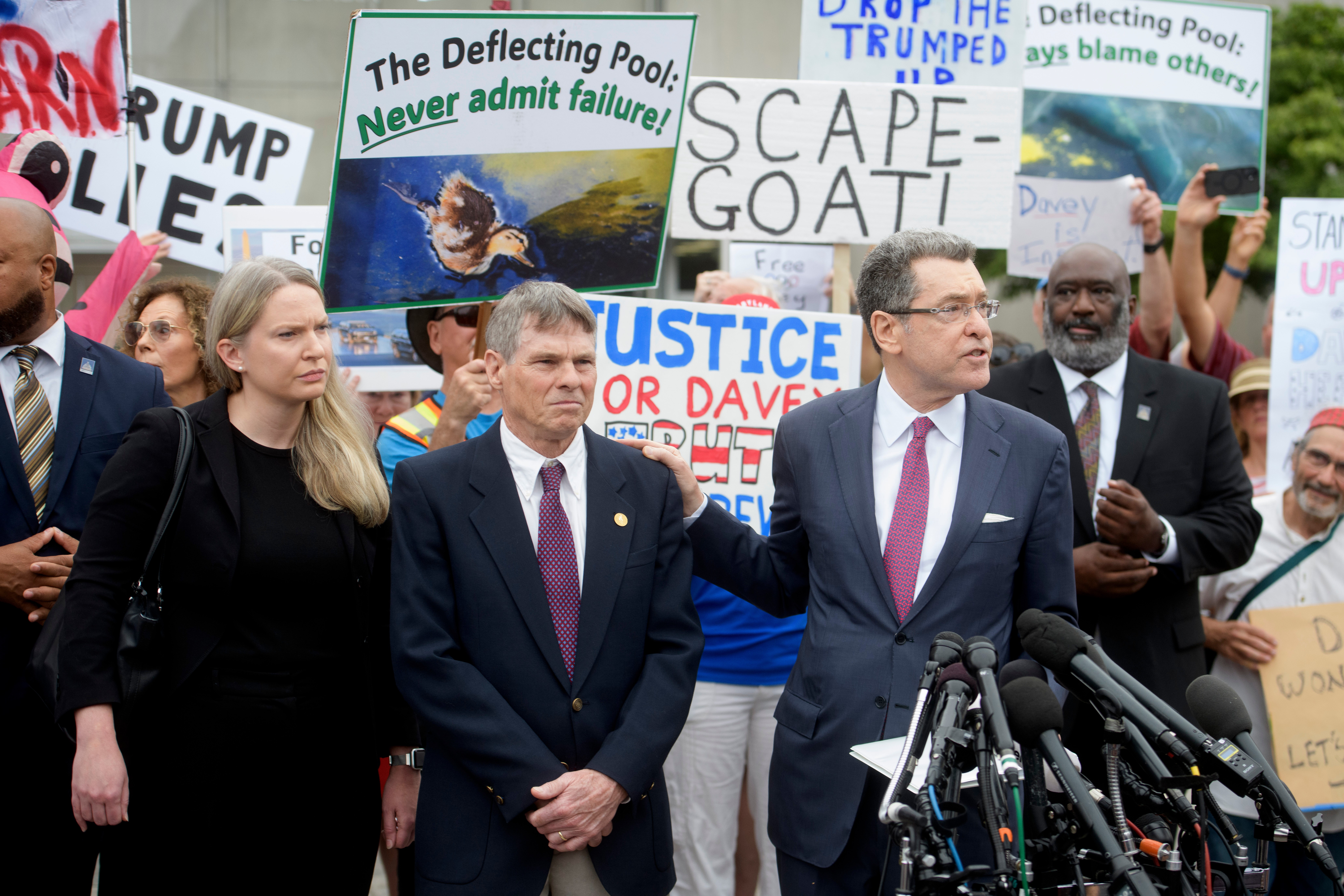 Former Olympic canoeist David Hearn, center, listens as his attorney Norman Eisen, right, speaks July 9 in Washington after Hearn pleaded not guilty to allegedly damaging the Lincoln Memorial Reflecting Pool. (Rod Lamkey/AP)
