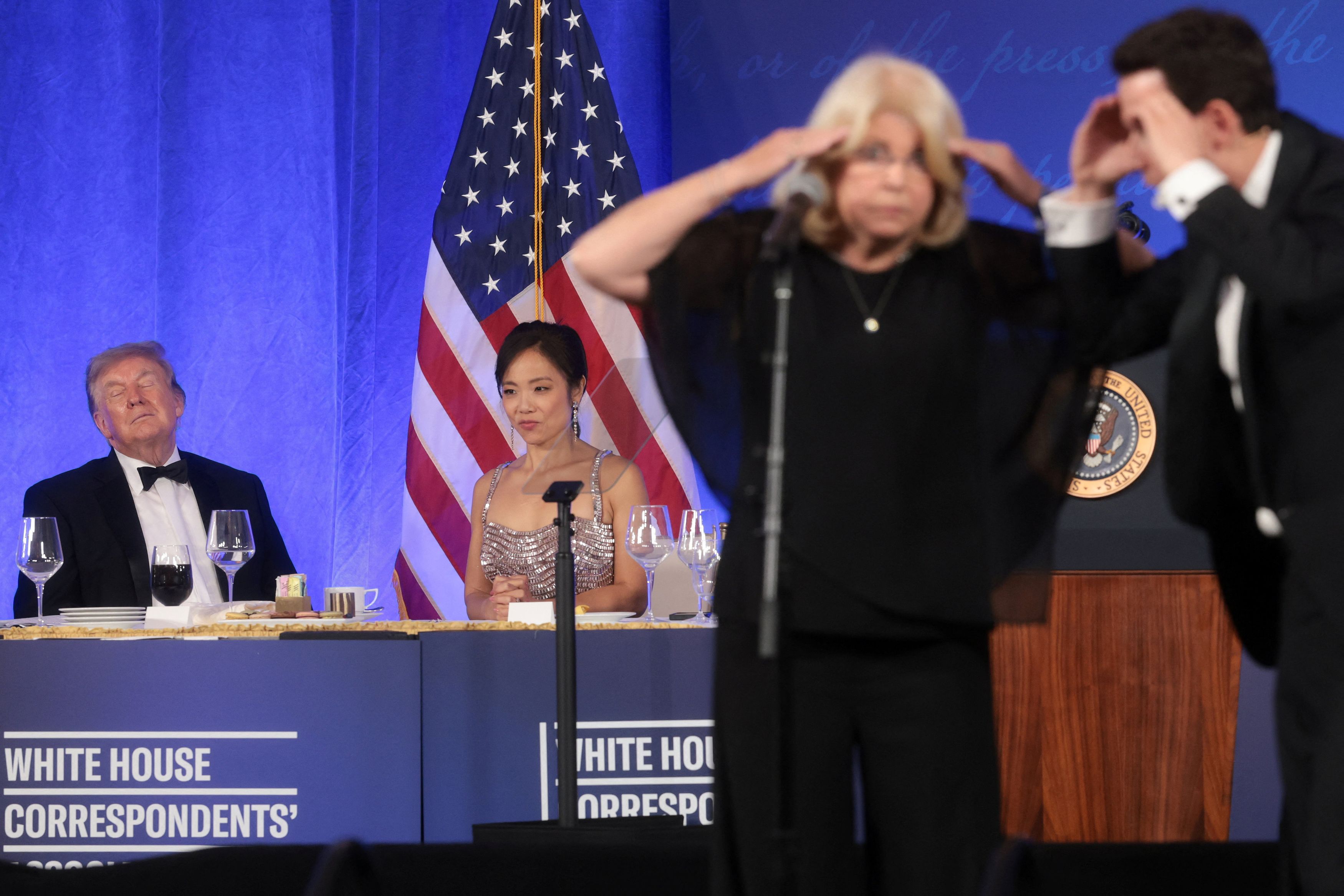 Trump and outgoing White House Correspondents' Association President and CBS News senior White House correspondent Weijia Jiang watch as Pearlman and an audience volunteer do a bit. (Jonathan Ernst/Reuters)