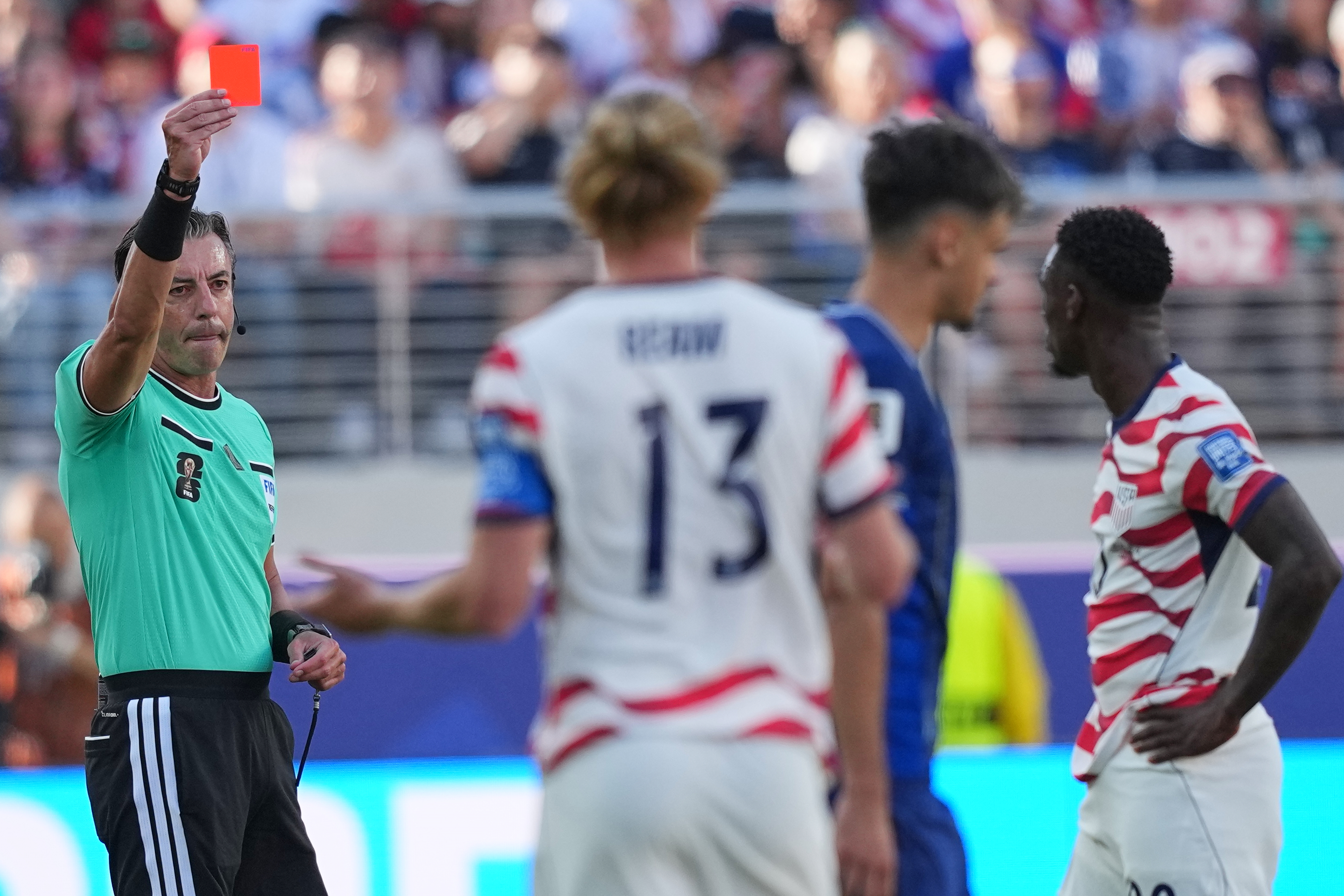 Folarin Balogun, right, got a red card during the round of 32 match between the U.S. and Bosnia. (Julio Cortez/AP)