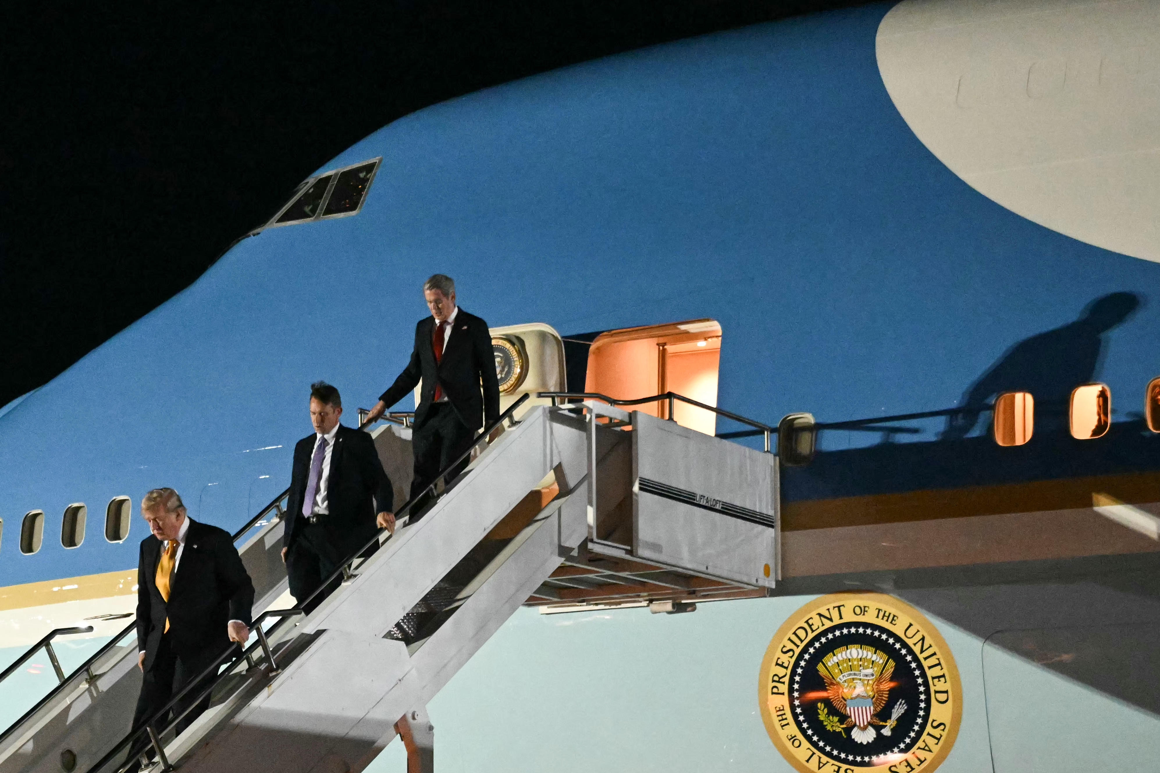 President Donald Trump disembarks from a legacy Air Force One after his arrival in Mildenhall, England, on July 8. (Saul Loeb/AFP/Getty Images)