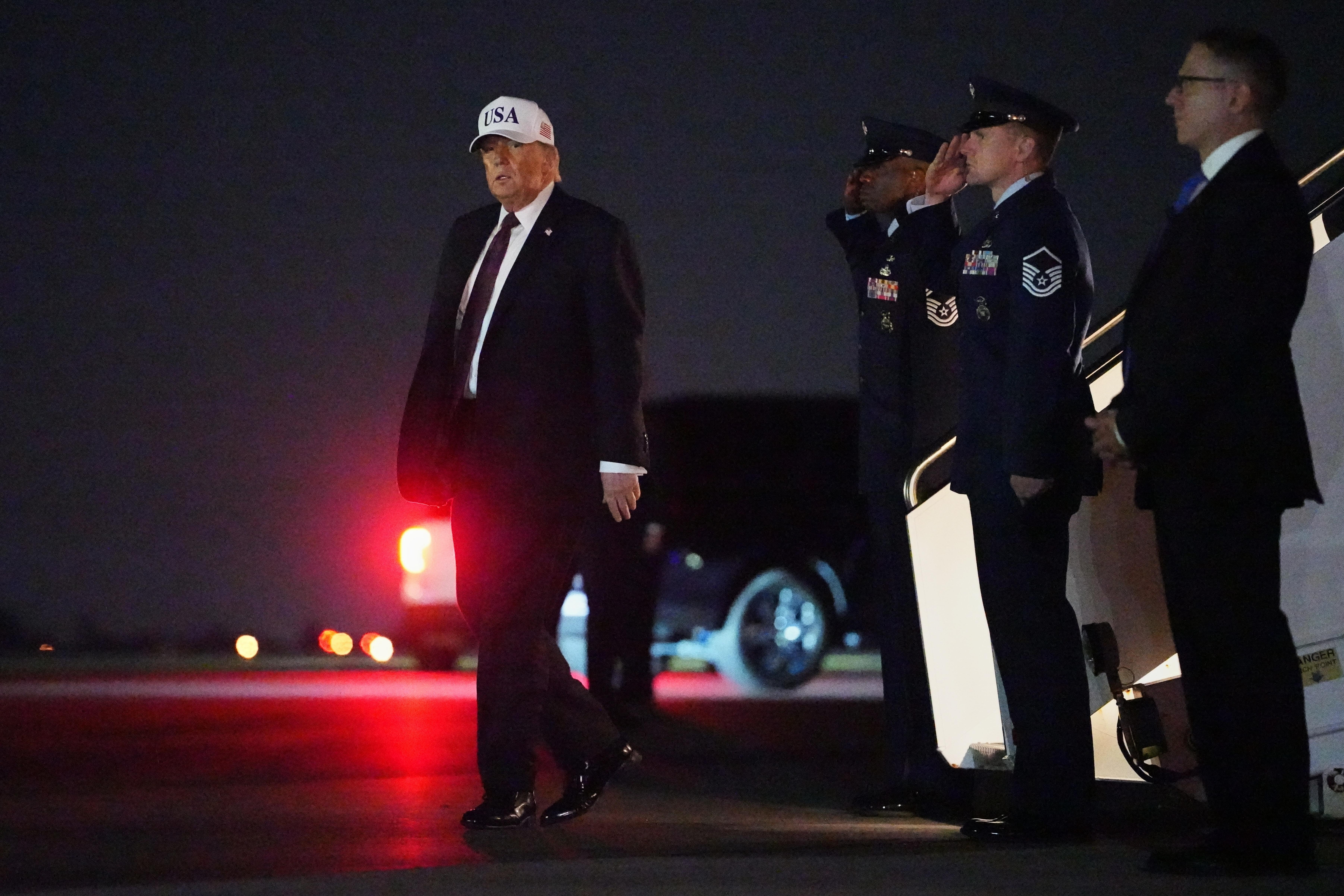 President Donald Trump disembarks Air Force One at Palm Beach International Airport in West Palm Beach, Fla., on Friday. (Matt Rourke/AP)