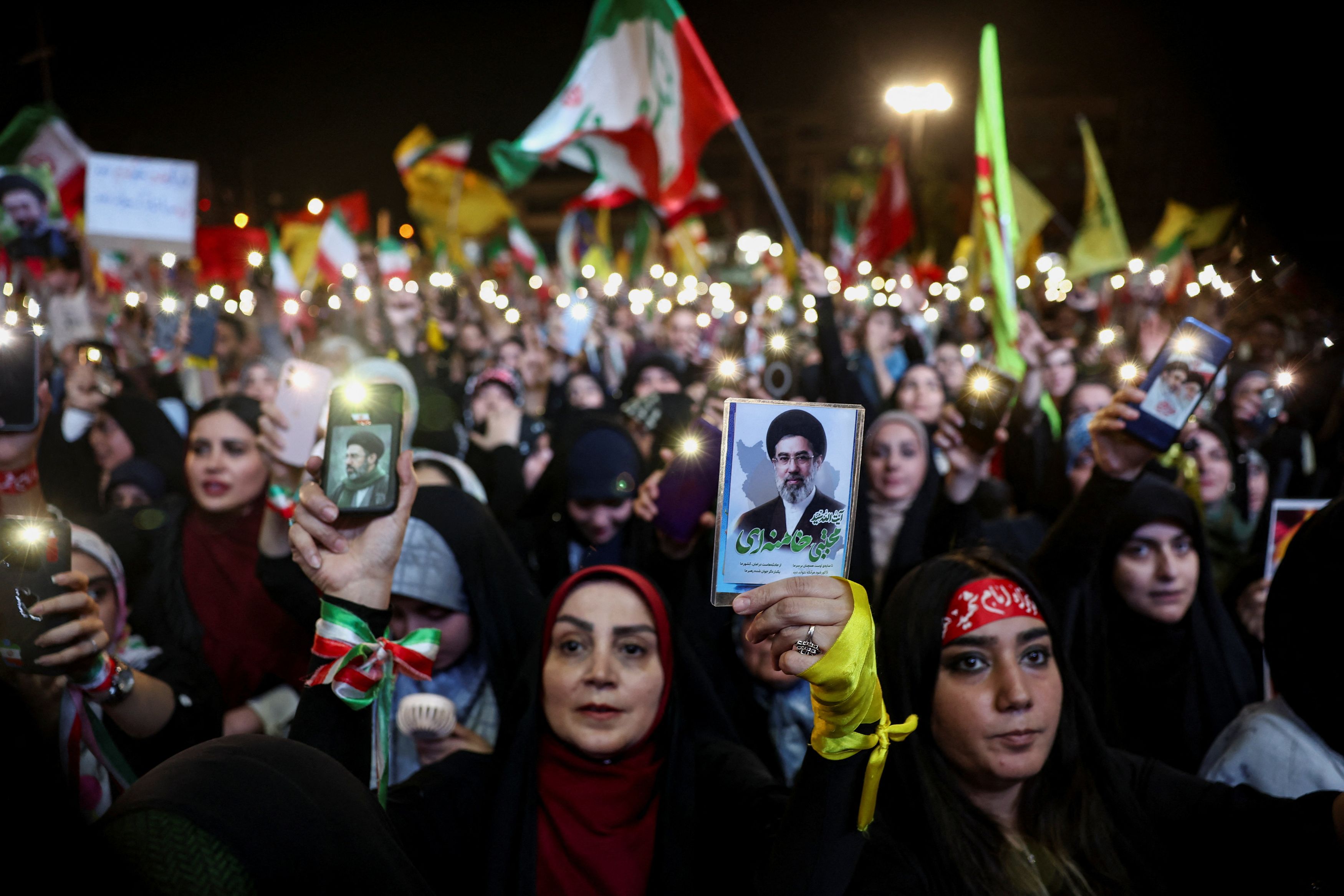 A woman holds an image of Iran's supreme leader, Mojtaba Khamenei, during an anti-U.S. and Israeli rally in Tehran following Iran's missile attack on Israel on Sunday. (Majid Asgaripour/via REUTERS)