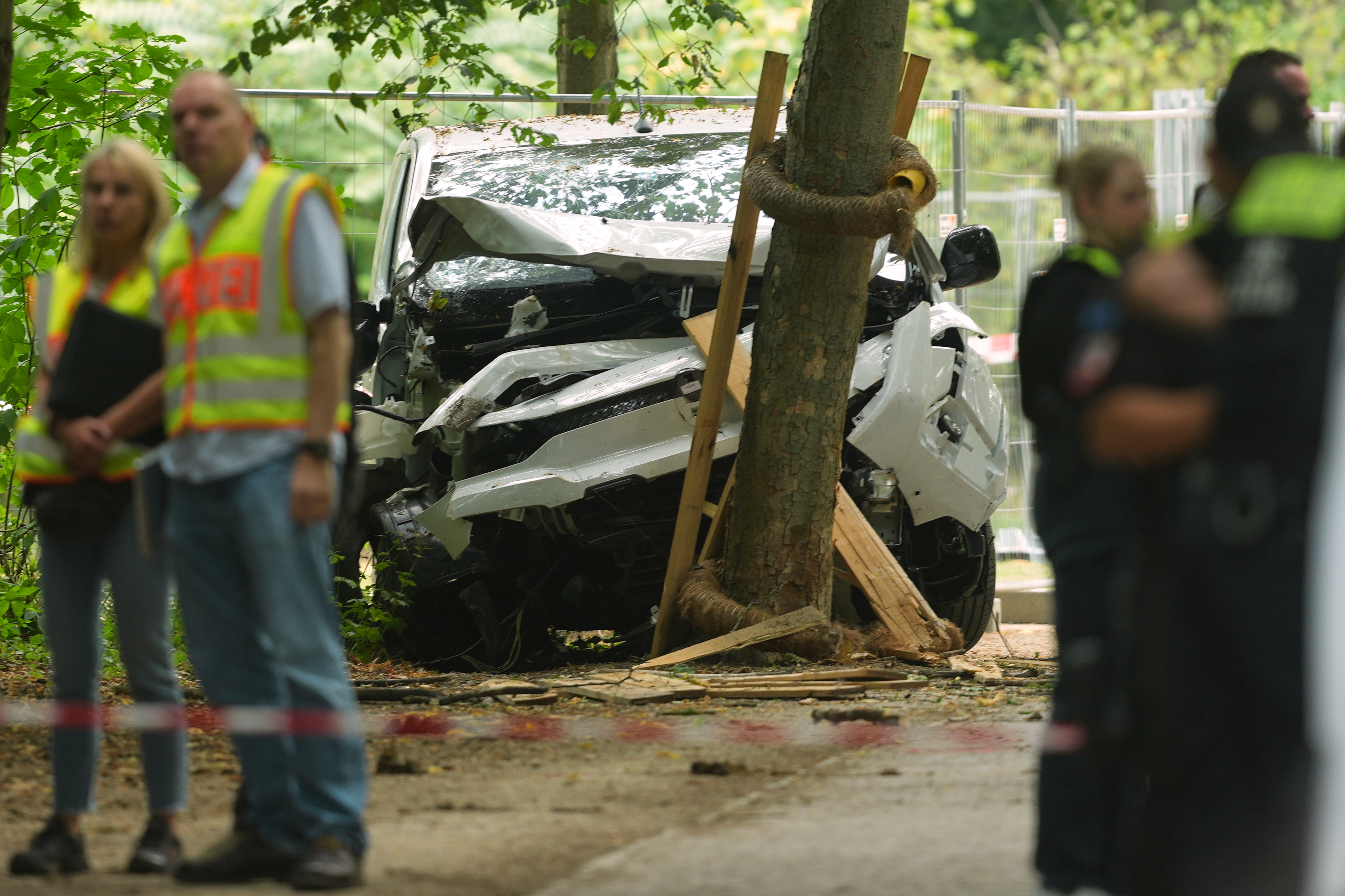 Officers secure the site where a vehicle rammed into parade attendees and crashed into a tree in Berlin on Sunday. (Markus Schreiber/AP)