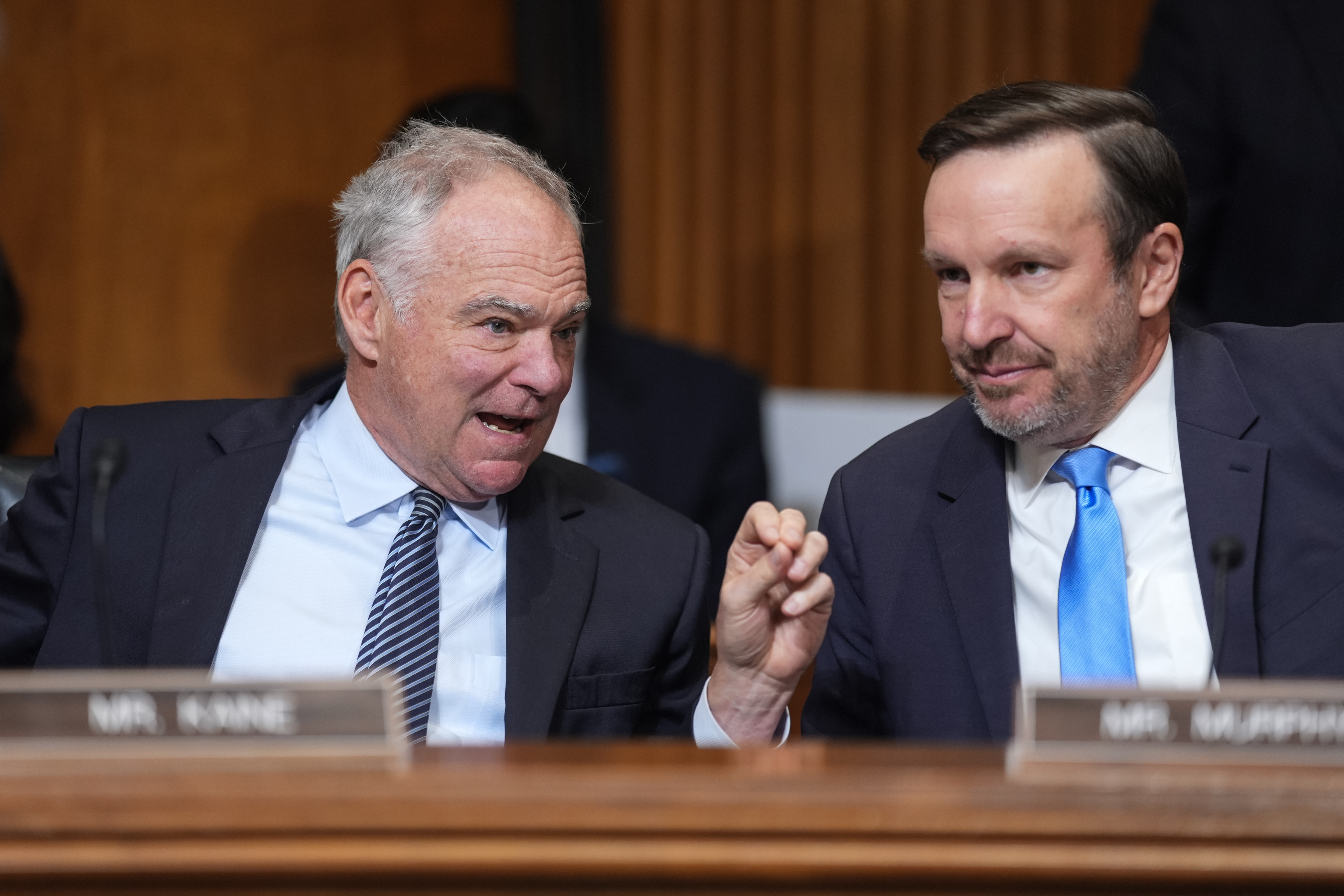 Sen. Tim Kaine (D-Virginia), left, and Sen. Chris Murphy (D-Connecticut) confer at the start of a Senate Foreign Relations Committee hearing in June. (J. Scott Applewhite/AP)