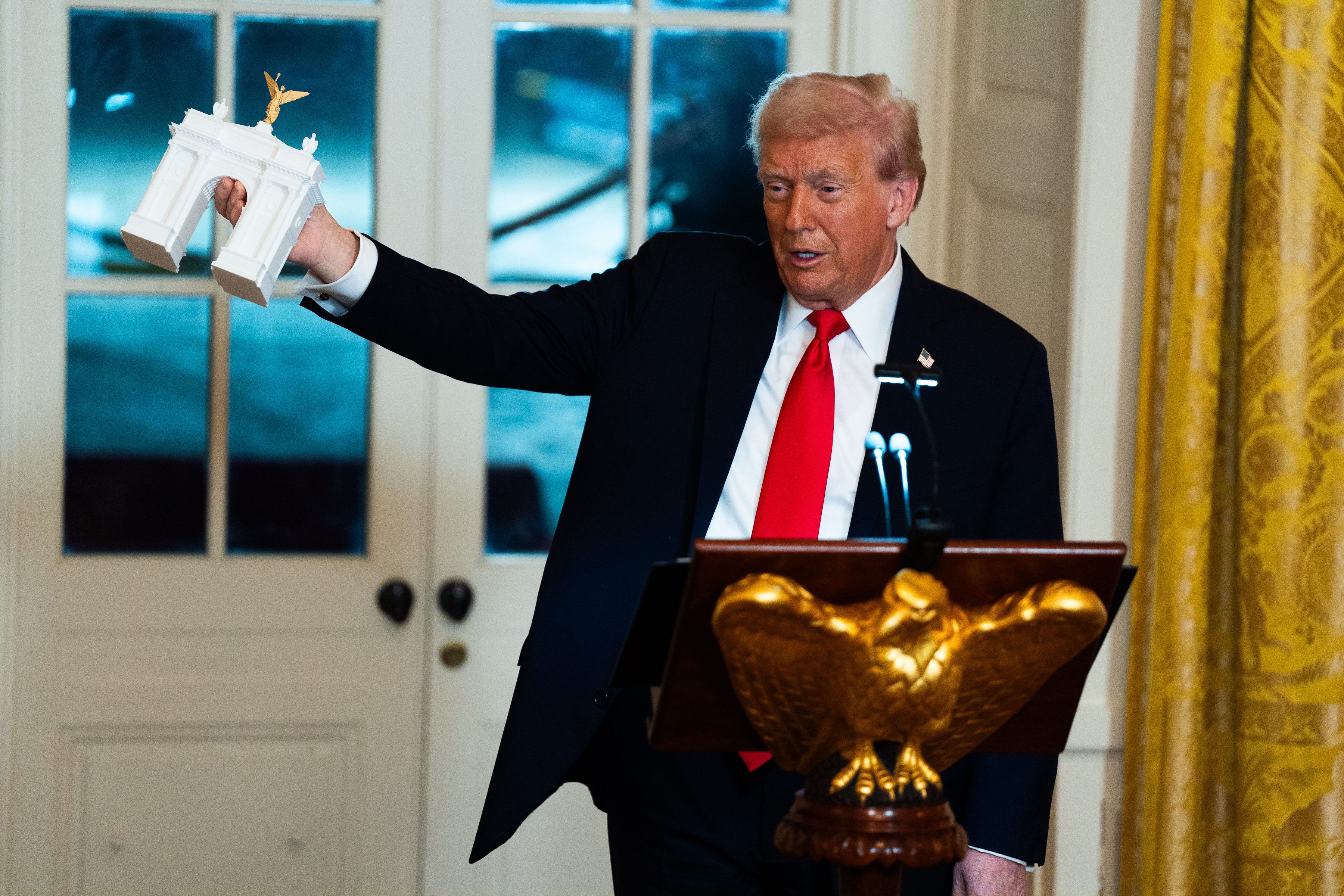 President Donald Trump with a model of his proposed arch. (Demetrius Freeman/The Washington Post)