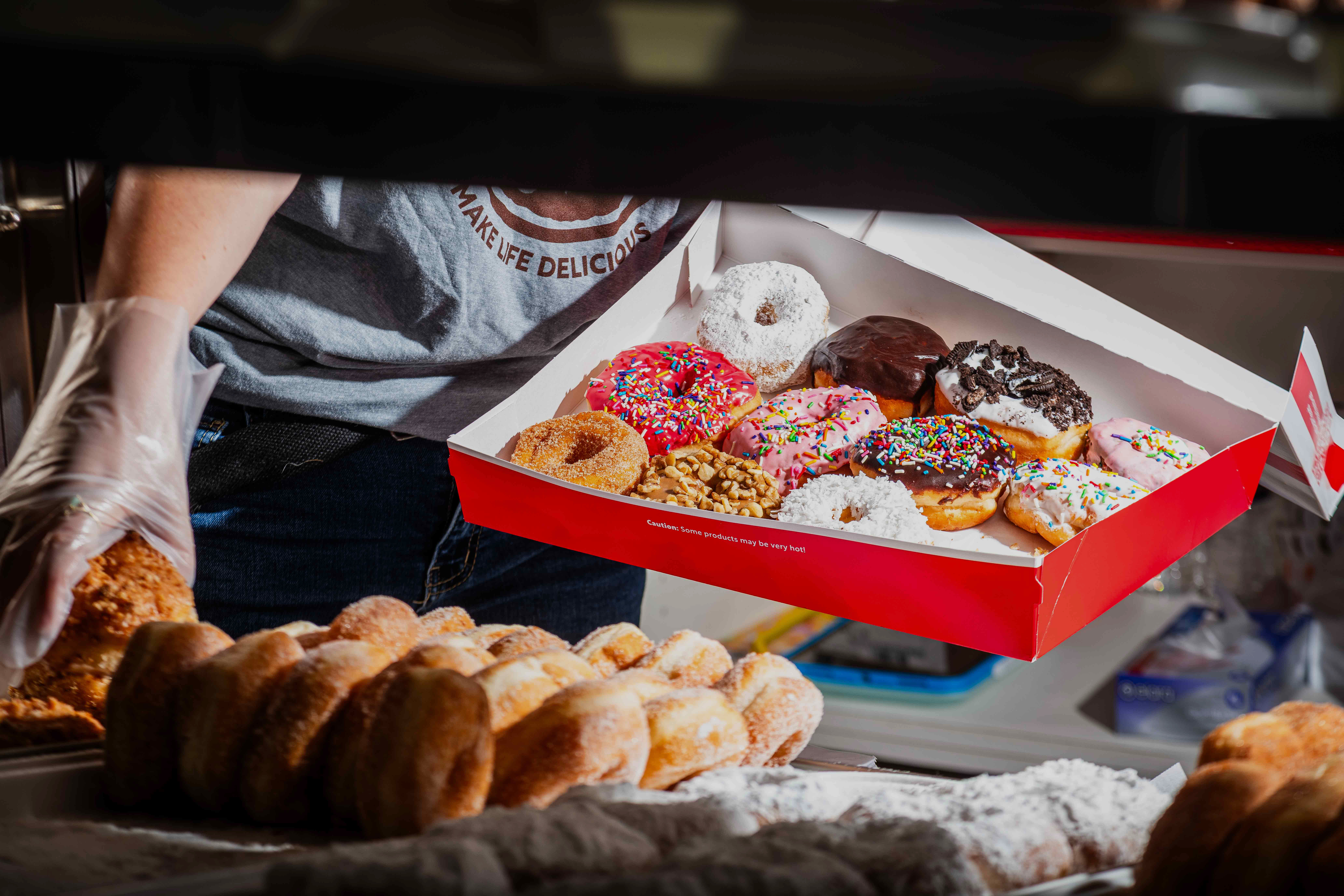 Fresh doughnuts are boxed up at Shipley's new Vienna location. (Rey Lopez/For The Washington Post)