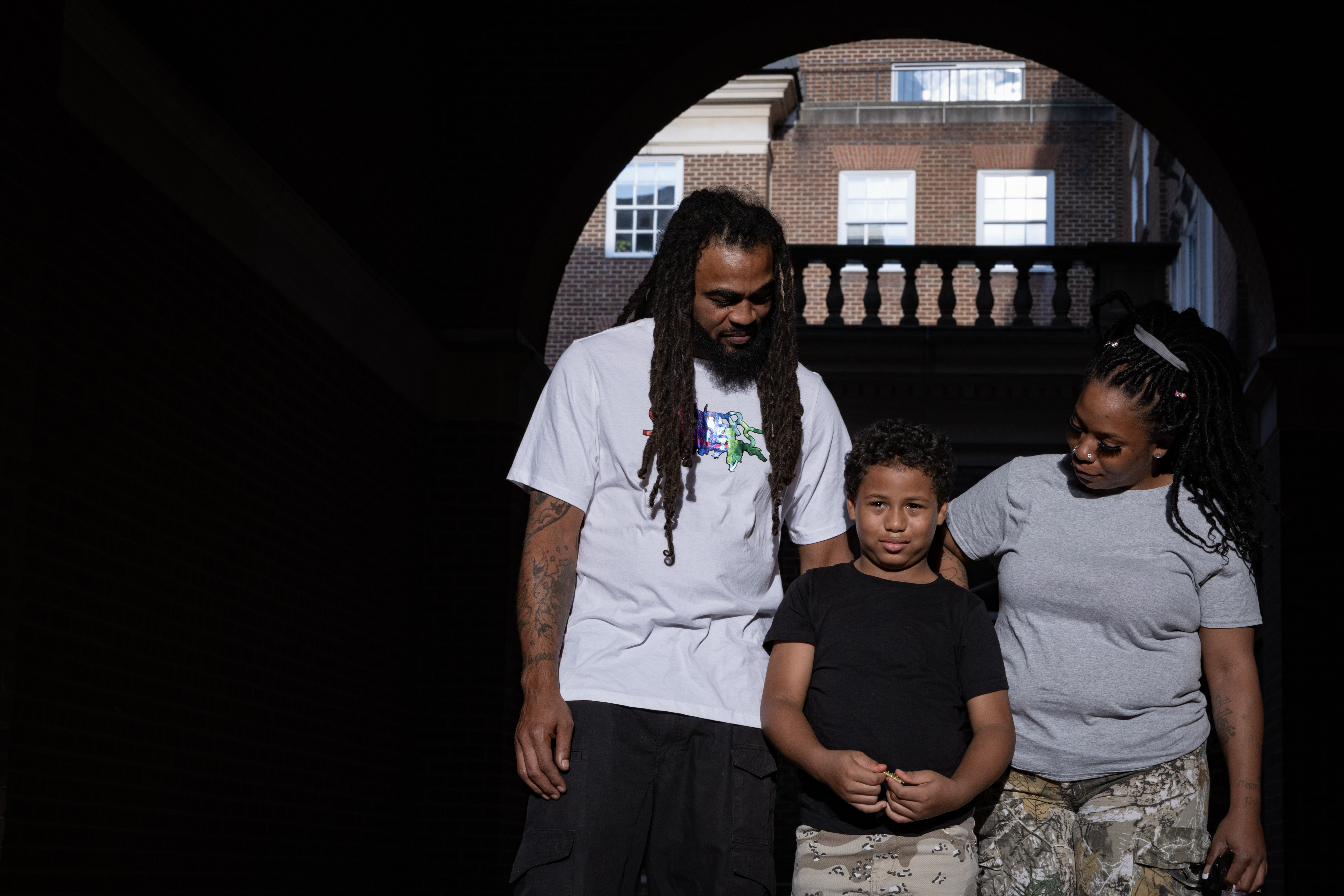 Duvel Brown, left, and Lakeia Miller, right, with their son Kuvel Brown, 8, on Aug. 11. (Tyler M. Andrews/The Washington Post)