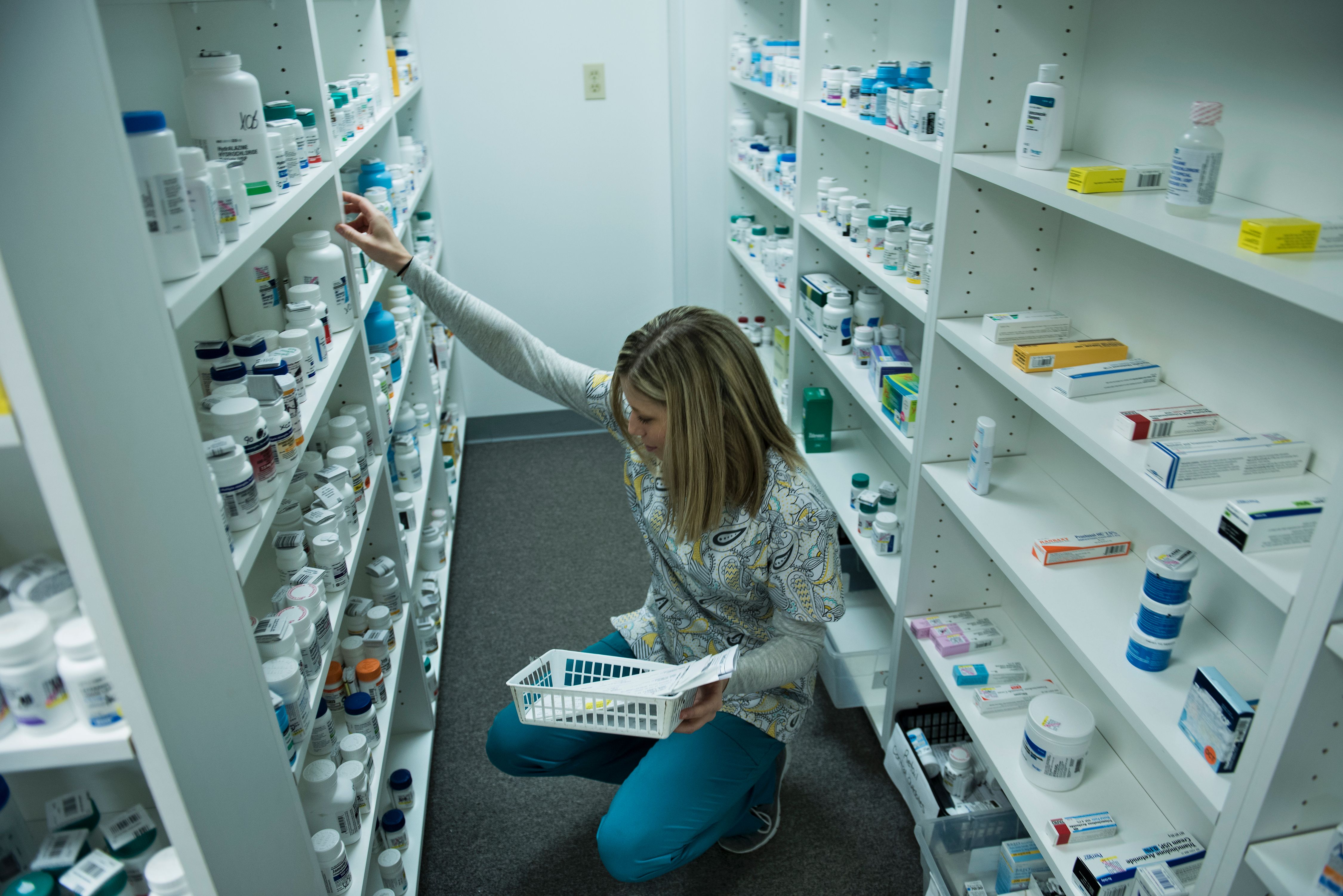 A staff member sorts through drugs while filling a prescription in 2017 at the Clay-Battelle Community Health Center's pharmacy in Blacksville, West Virginia. (BRENDAN SMIALOWSKI/AFP/Getty Images)