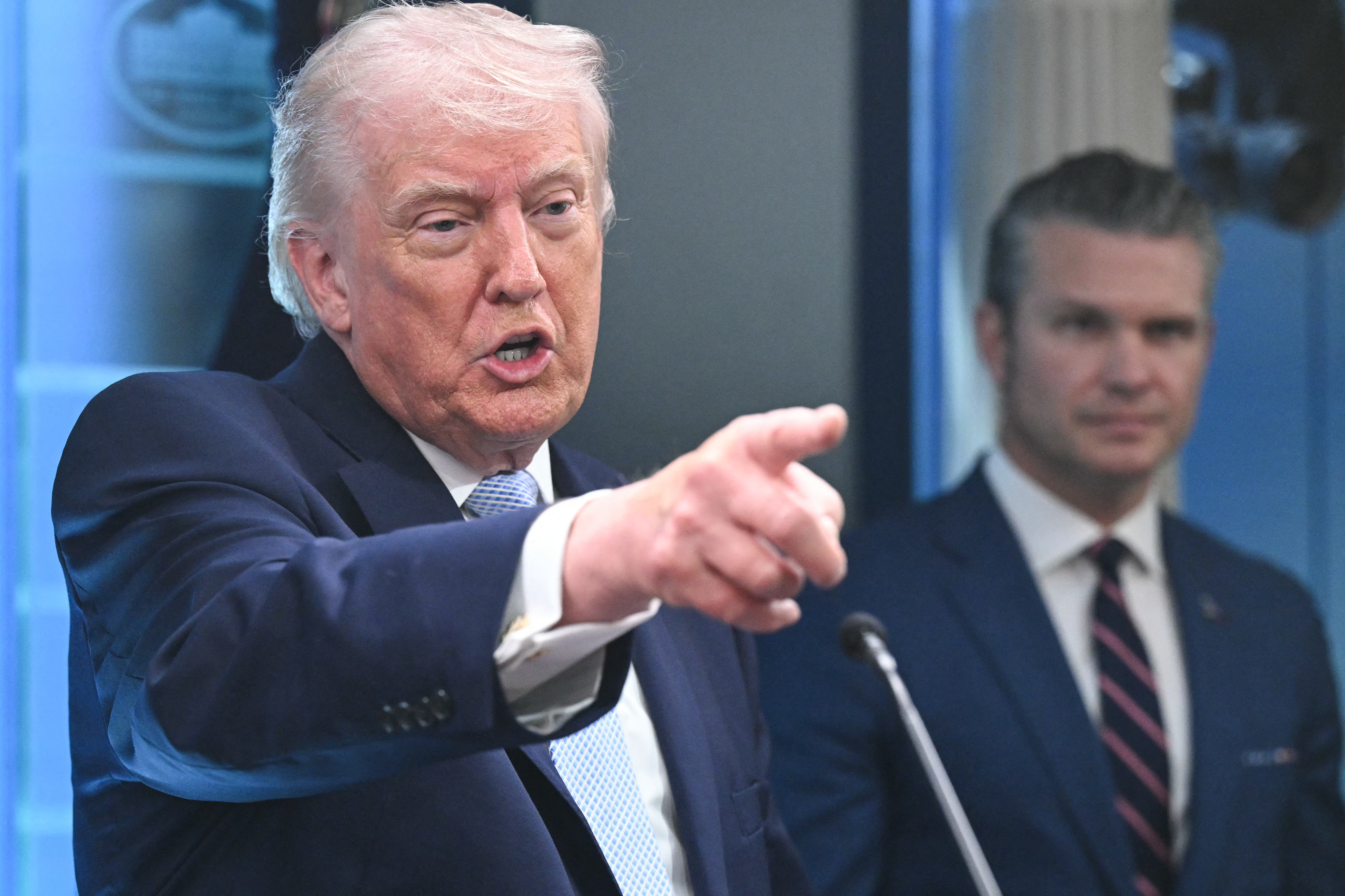 President Donald Trump, alongside Secretary of Defense Pete Hegseth, speaks about the conflict in Iran at the White House on Monday. (Saul Loeb/AFP/Getty Images)