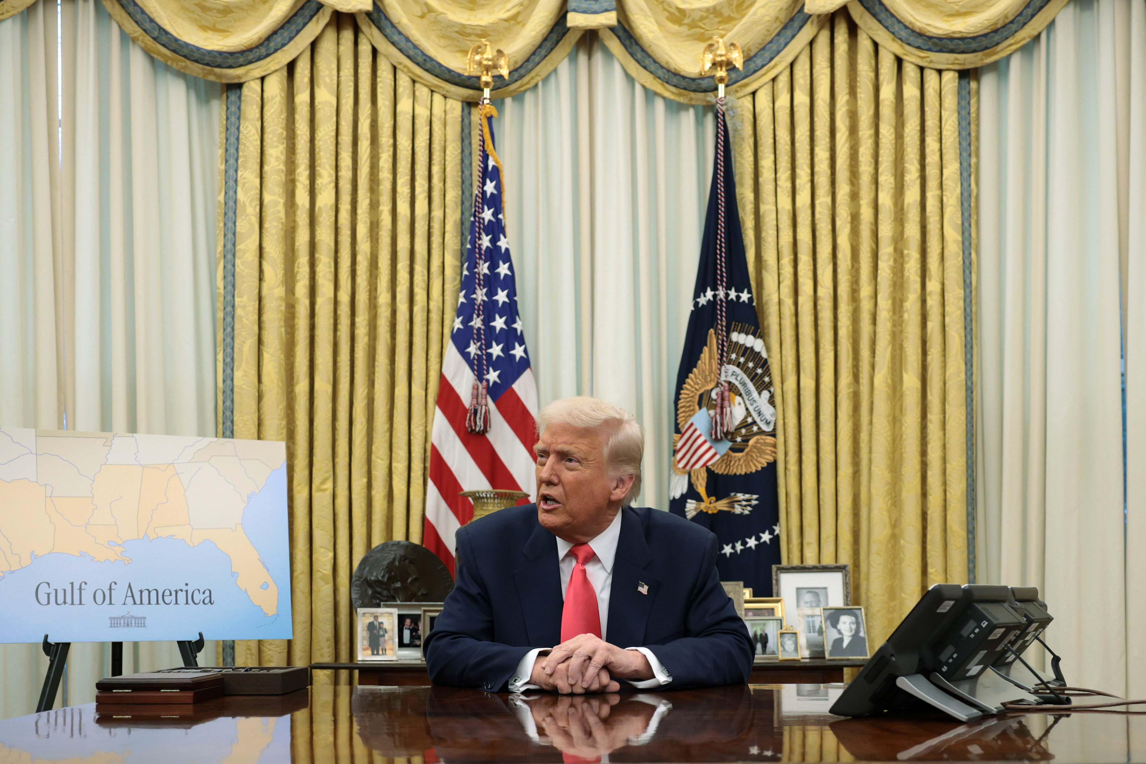 President Donald Trump signs executive orders in the Oval Office in March 2025. (Alex Wong/Getty Images)