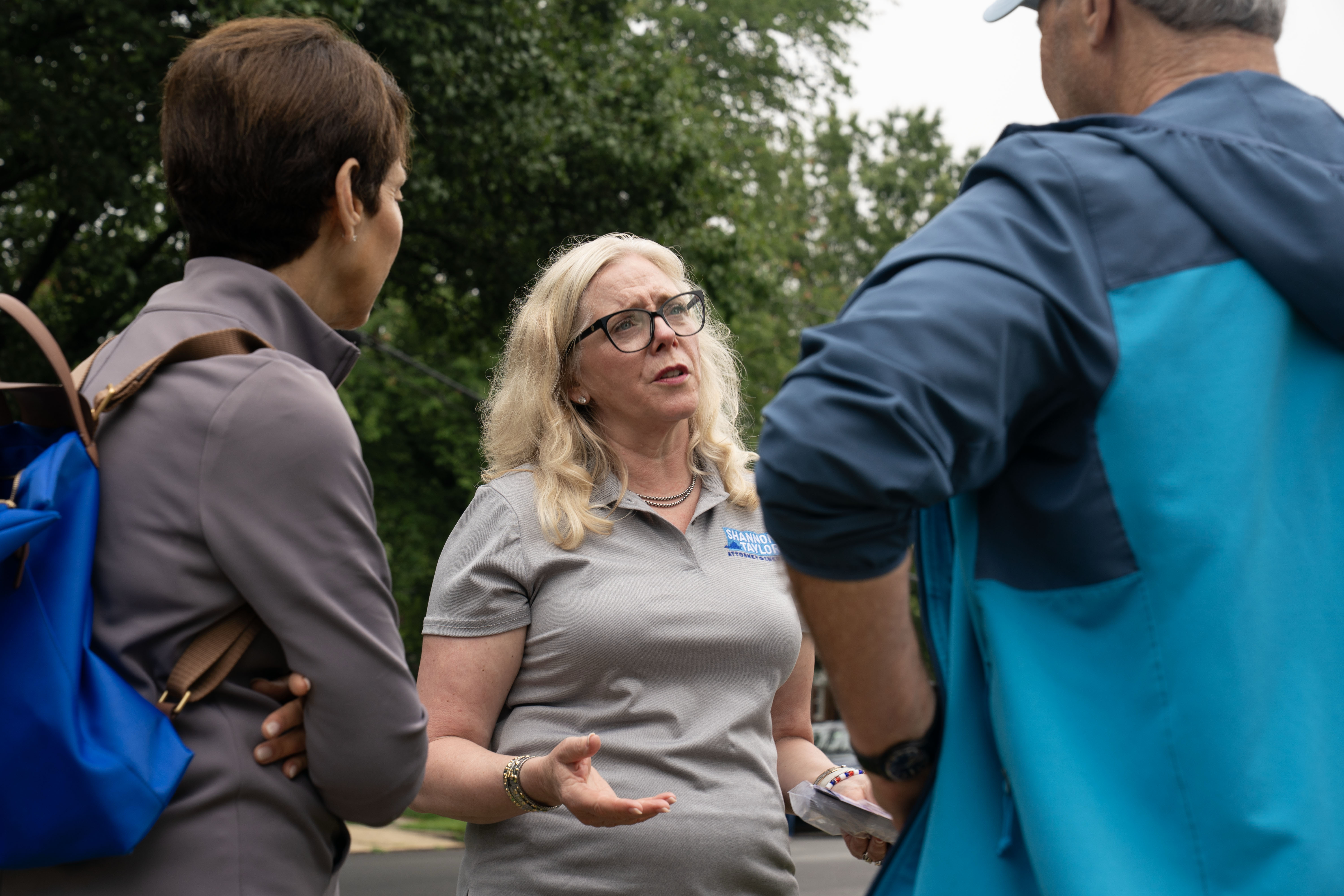 Shannon Taylor, center, outside an Alexandria, Virginia, polling station in June 2025. (Maxine Wallace/The Washington Post)