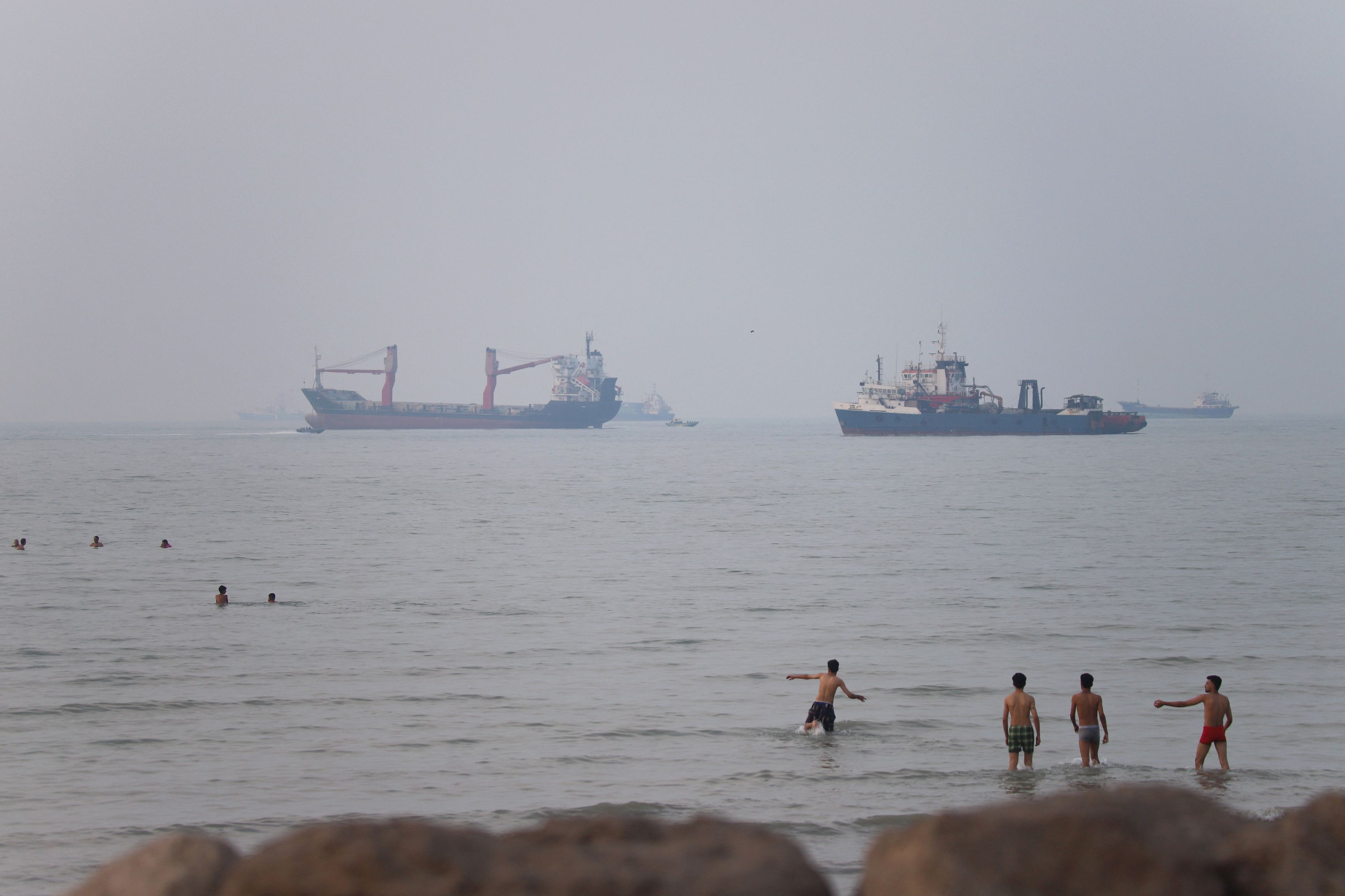 Vessels in the Strait of Hormuz near the beach of Bandar Abbas, Iran, on June 30. (Amirhosein Khorgooi/ISNA/Reuters)