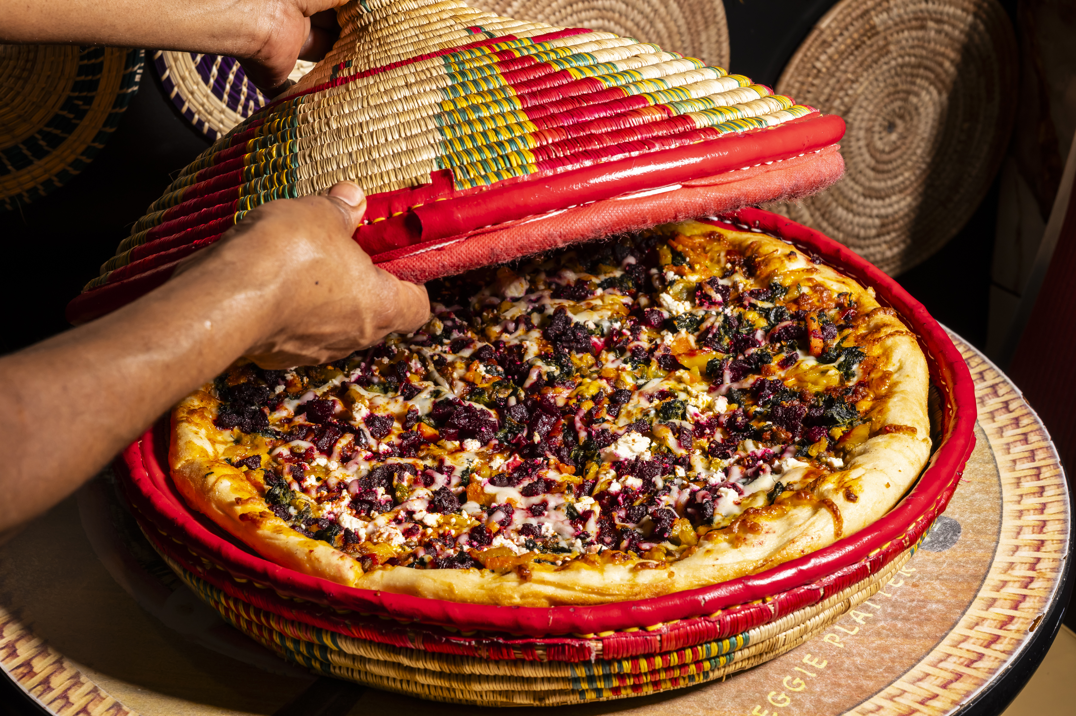 Pizzas, like the Addis Ababa seen here, arrive in a traditional woven basket called a mesob.