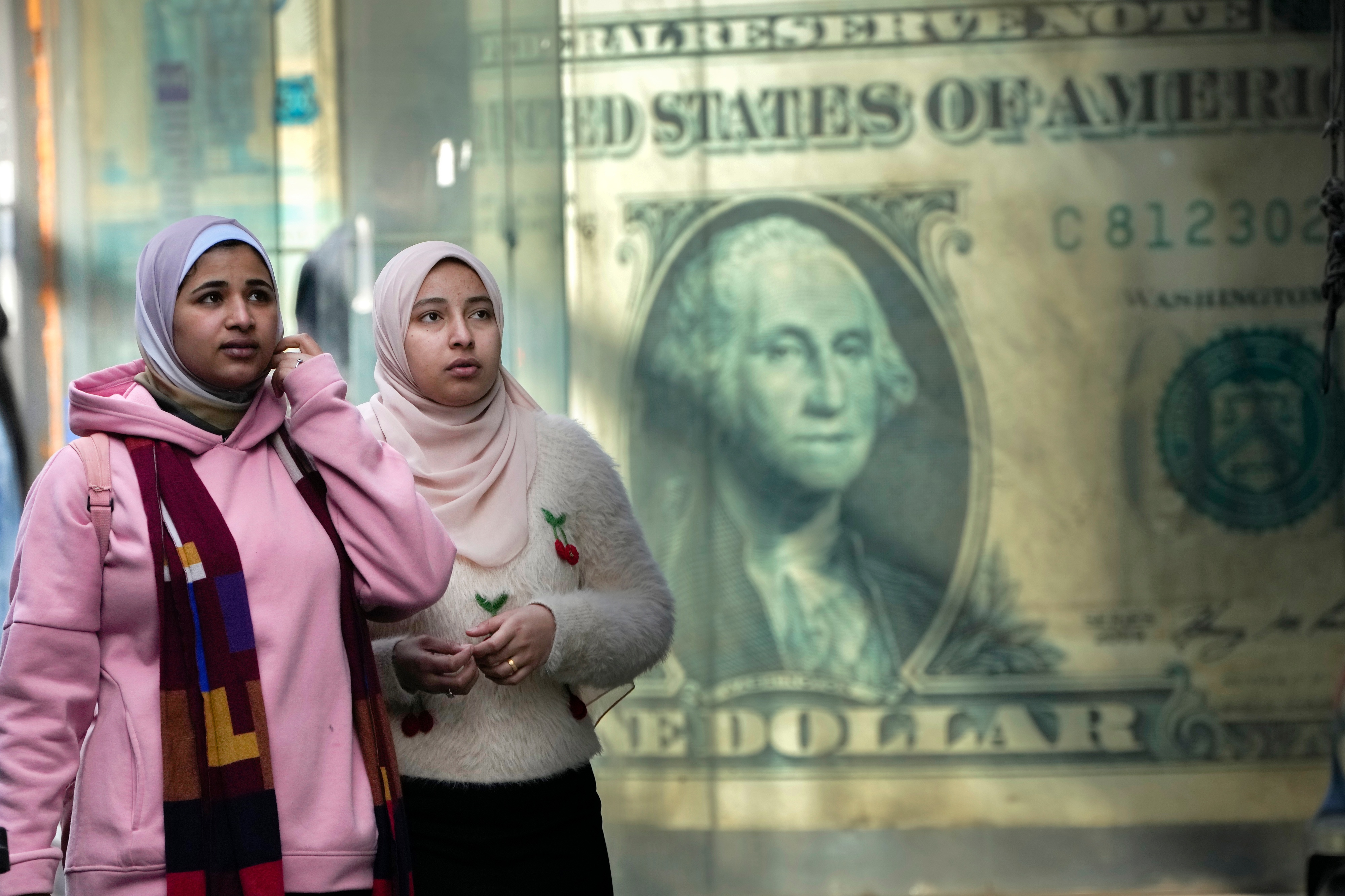 A poster depicting a U.S. dollar hangs at an exchange office in Cairo. The value of the dollar is up more than 5 percent since the end of January. (Amr Nabil/AP)