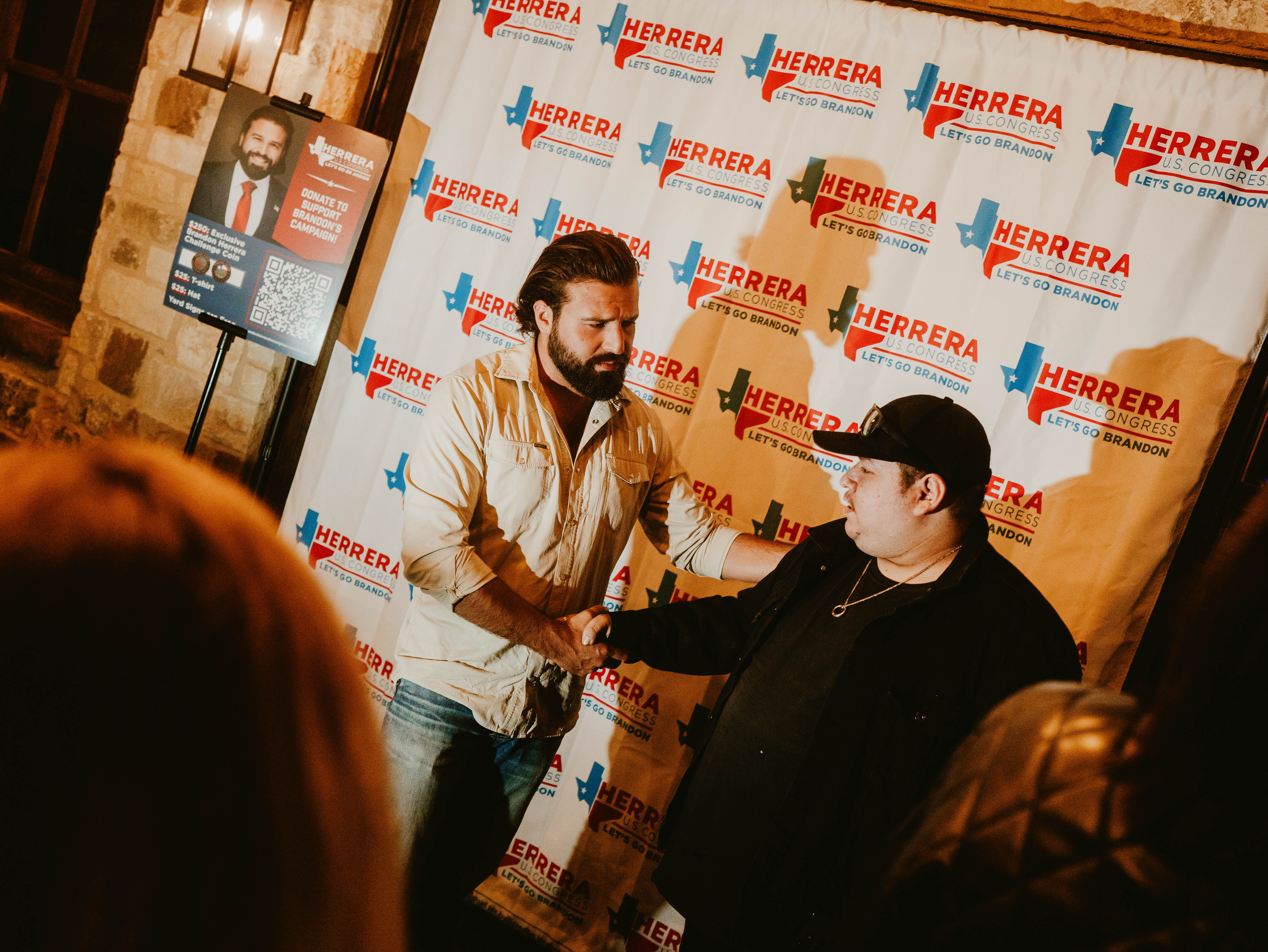 Brandon Herrera, left, a Republican congressional candidate for Texas’s 23rd District, speaks with a supporter in Uvalde, Texas, on Wednesday. (Brenda Bazán/For The Washington Post)