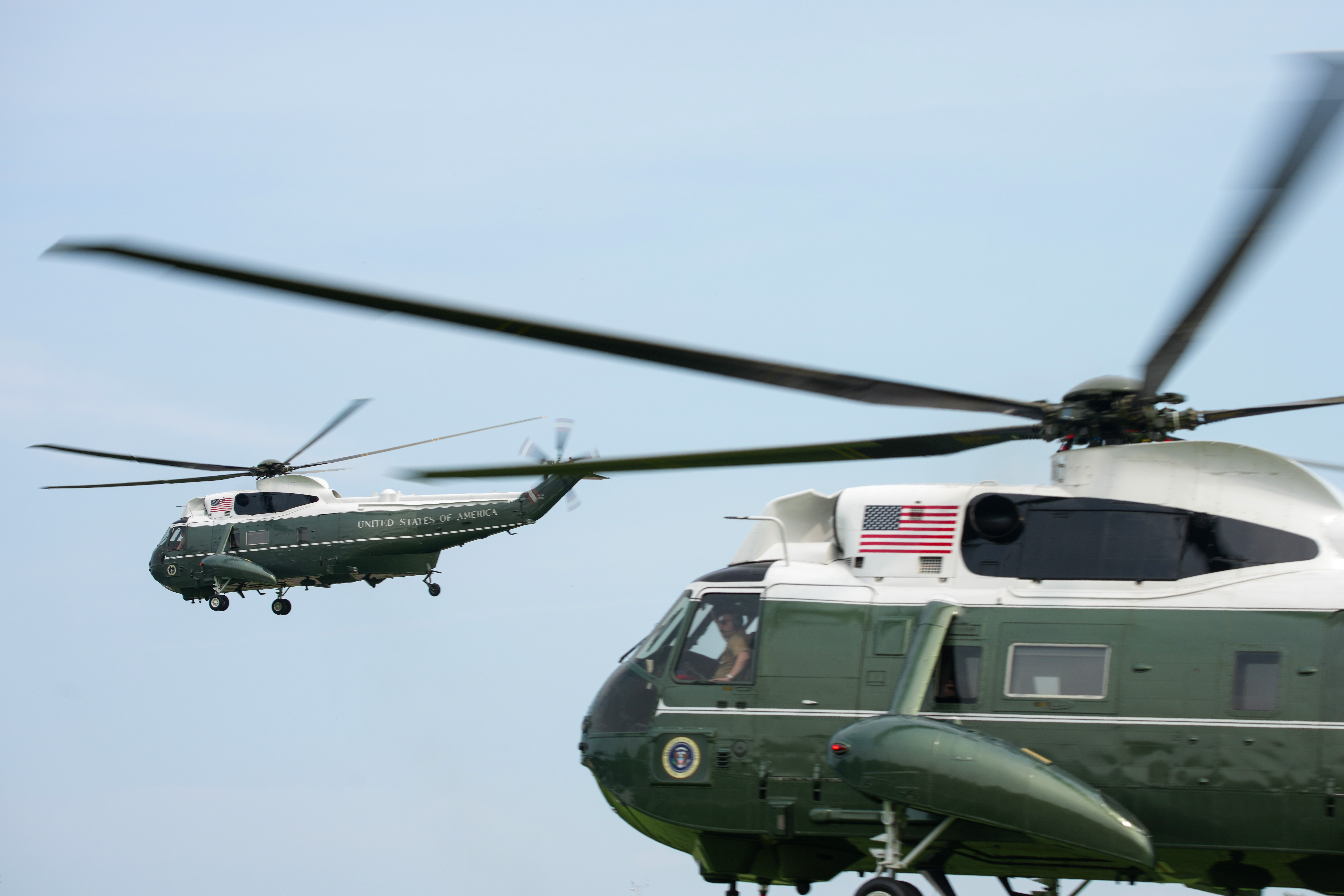 Marine One, left, carries President Donald Trump as it departs from the Ellipse near the White House on Aug. 11. (Andrew Harnik/Getty Images)