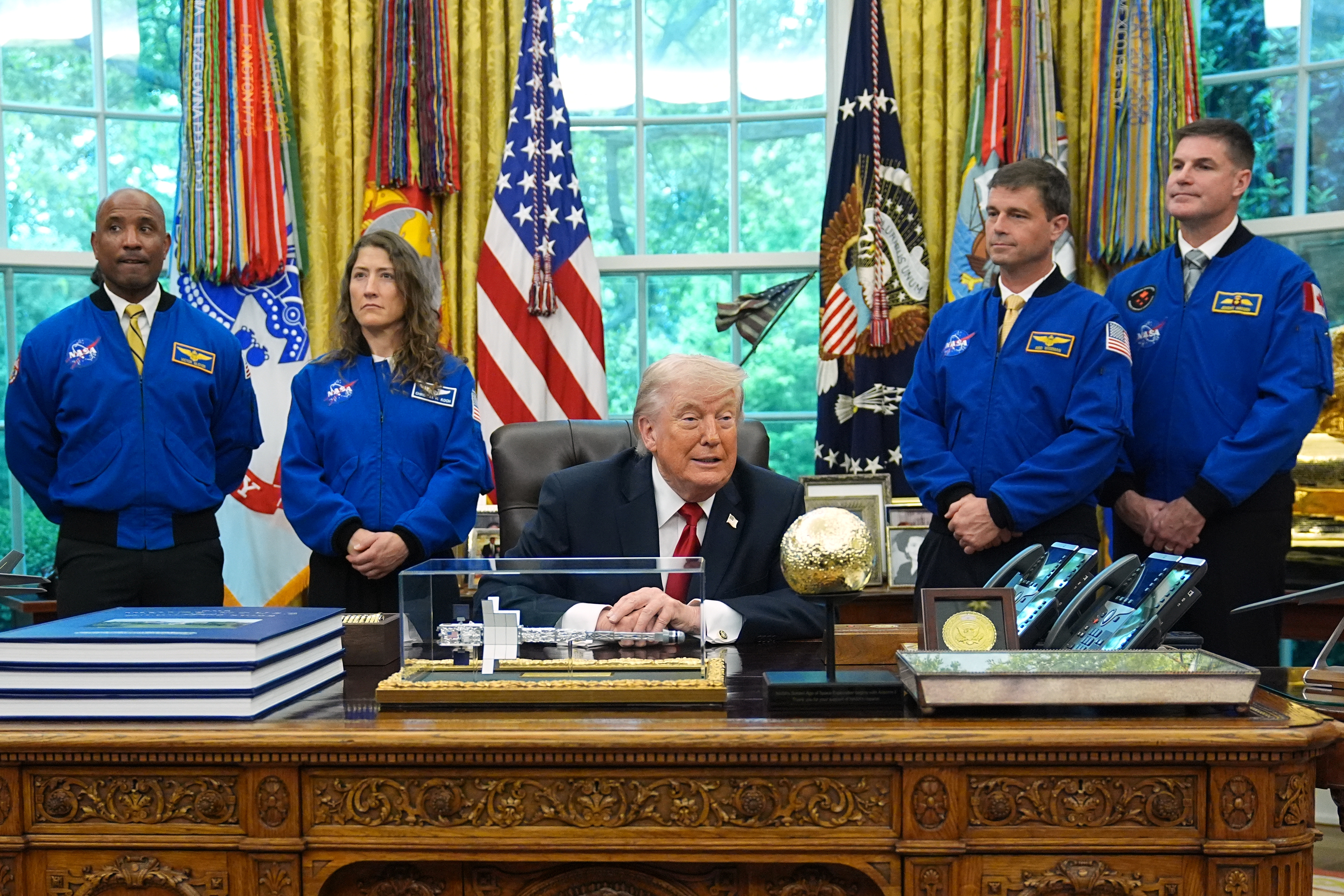 President Donald Trump with Artemis II astronauts, from left, Victor Glover, Christina Koch, Reid Wiseman and Jeremy Hansen in the Oval Office on Wednesday. (Matt Rourke/AP)