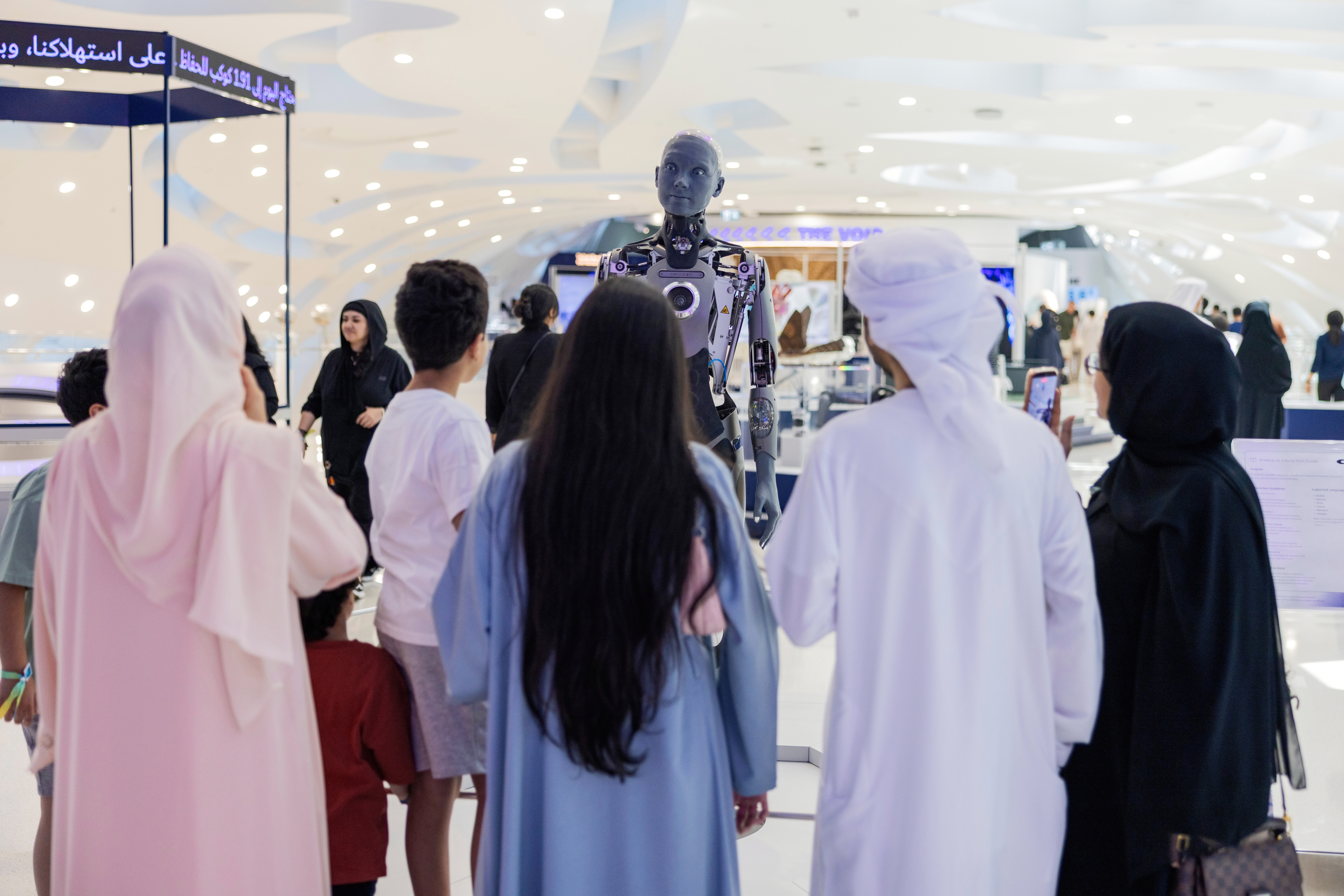 Ameca, an AI robot at the Museum of the Future, interacts with museum visitors in June.