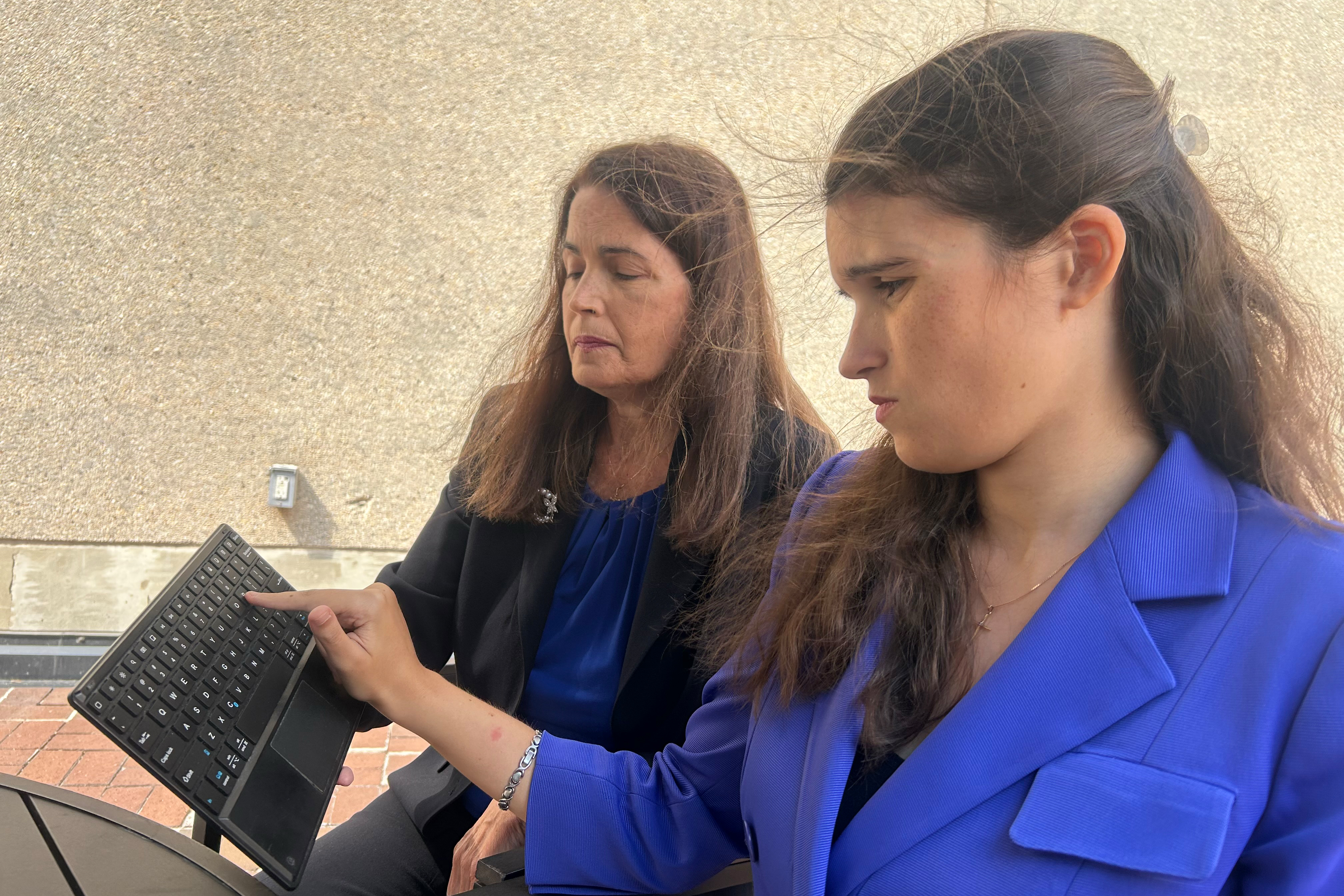Elizabeth Bonker, right, a self-described “speller” who cannot talk, sits on a federal autism panel. (Arthur Allen/KFF Health News)