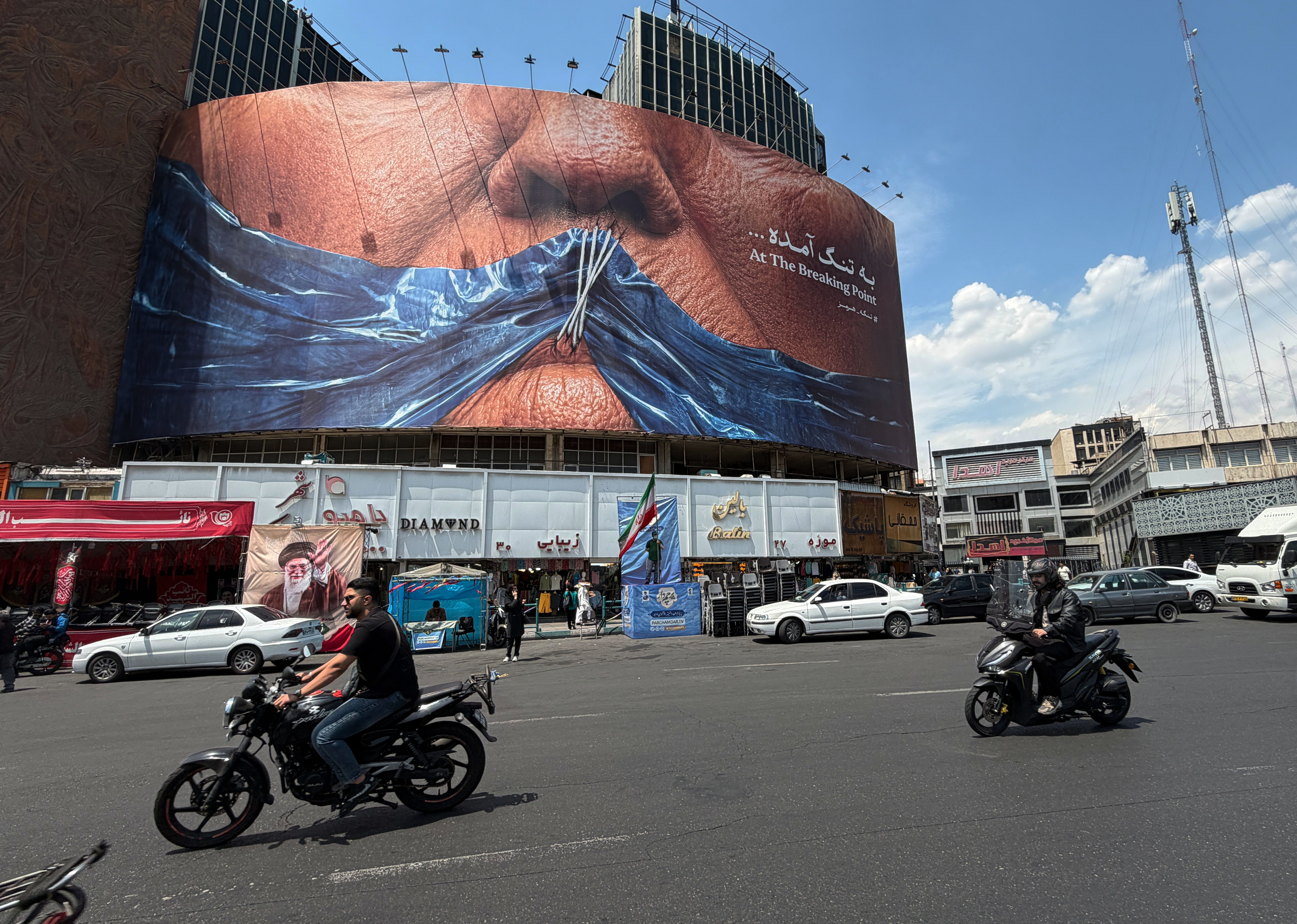 A Tehran billboard shows the Strait of Hormuz sealing President Donald Trump’s lips. (Vahid Salemi/AP)