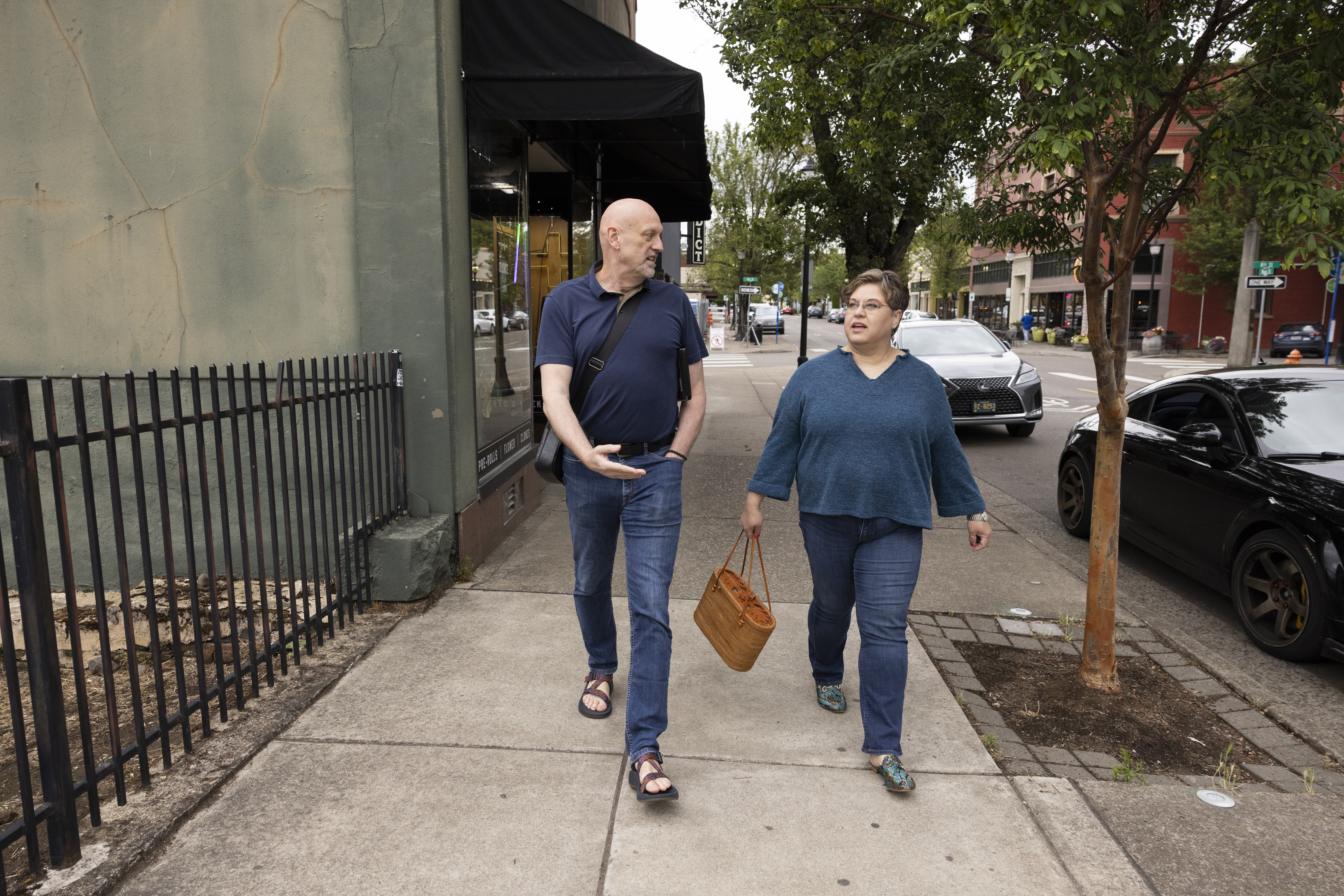 John Dekalb, left, and Jo Becker, walk back to their cars after meeting with friends in Oregon City, Oregon, last month. (Kristina Barker/For The Washington Post)
