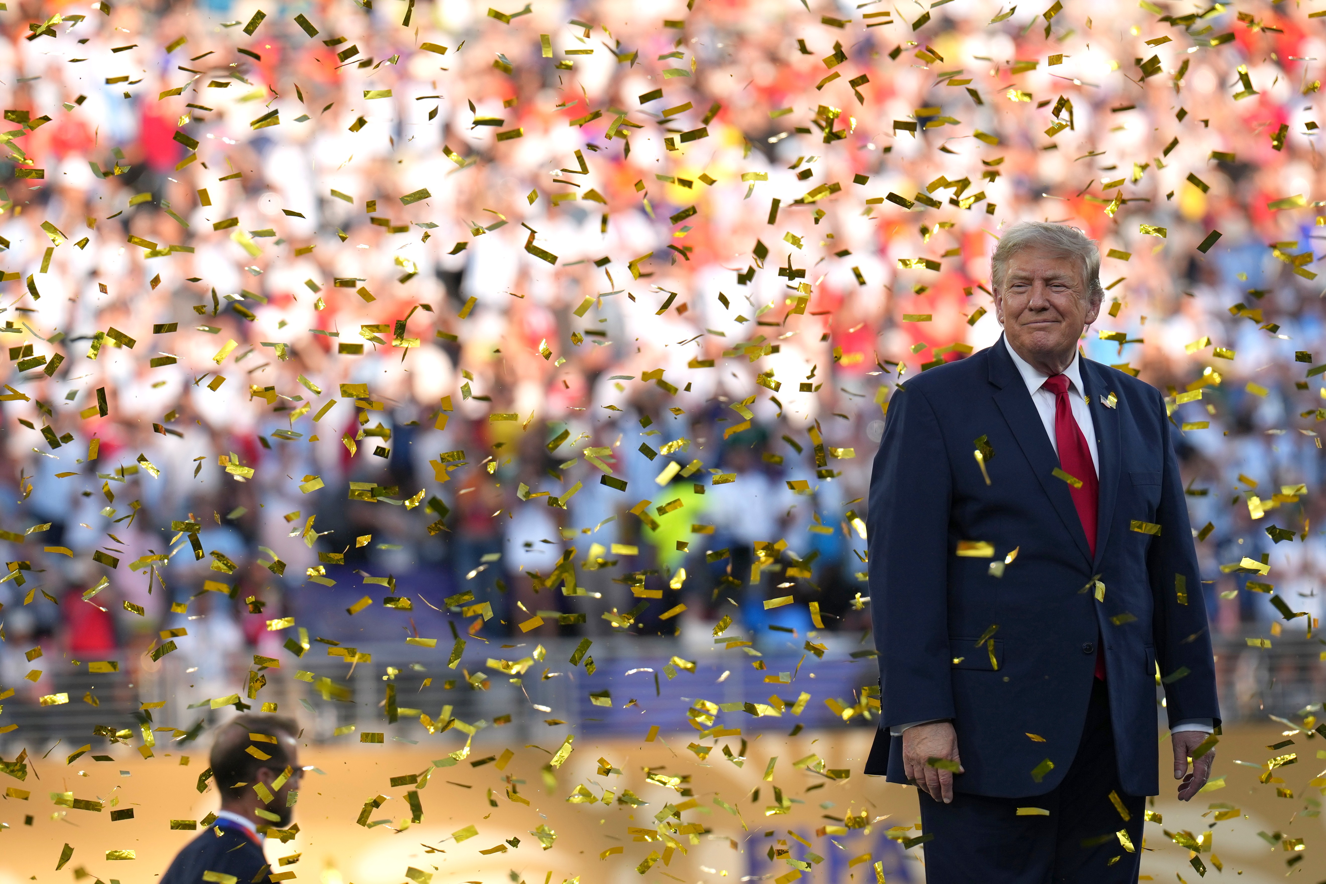 President Donald Trump smiles as confetti rains down on the field after the final World Cup match on Sunday. (Jacquelyn Martin/AP)