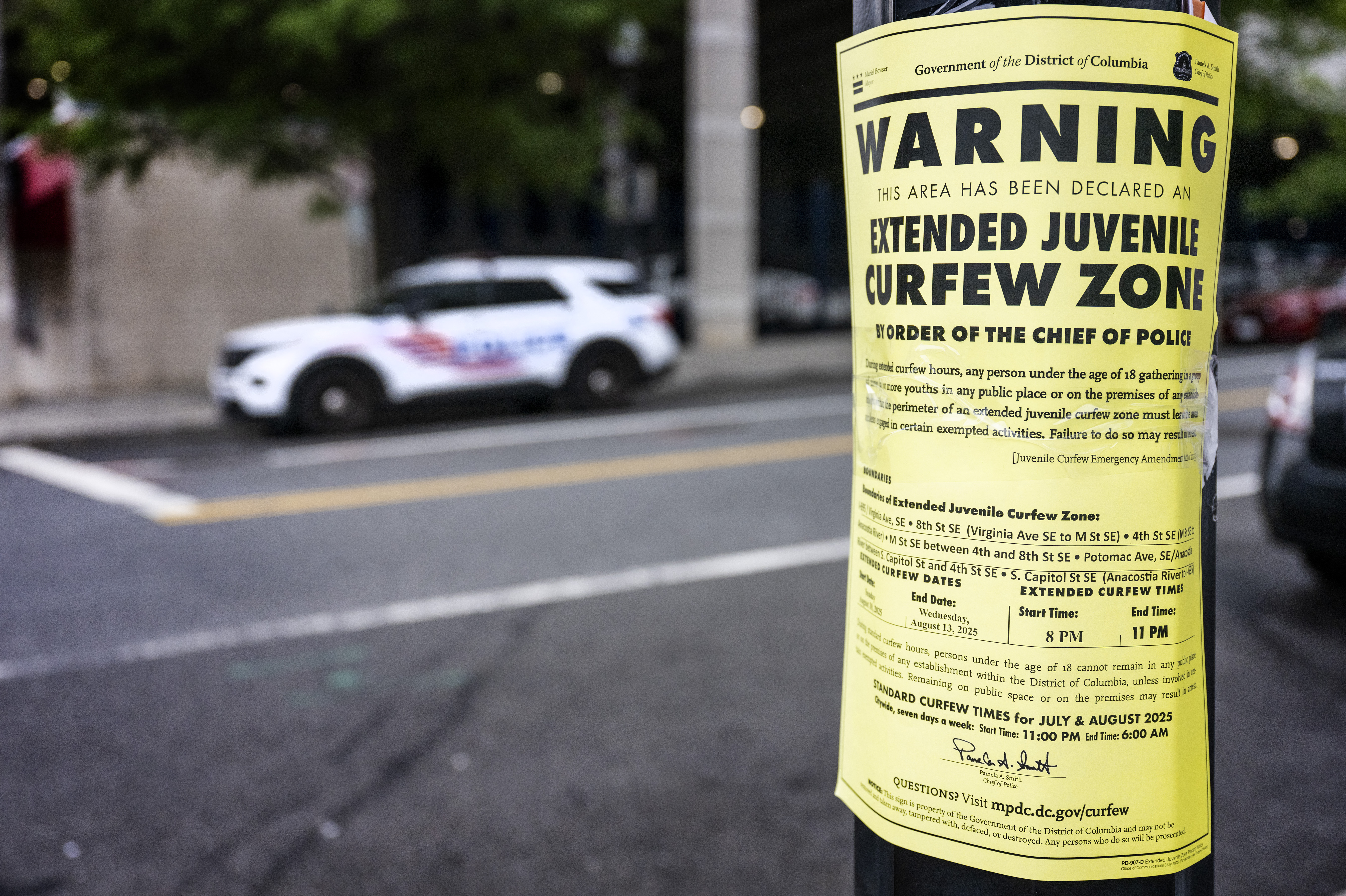 A placard warns that a curfew for juveniles is in effect in the Navy Yard neighborhood of Washington. (JIM WATSON/AFP via Getty Images)