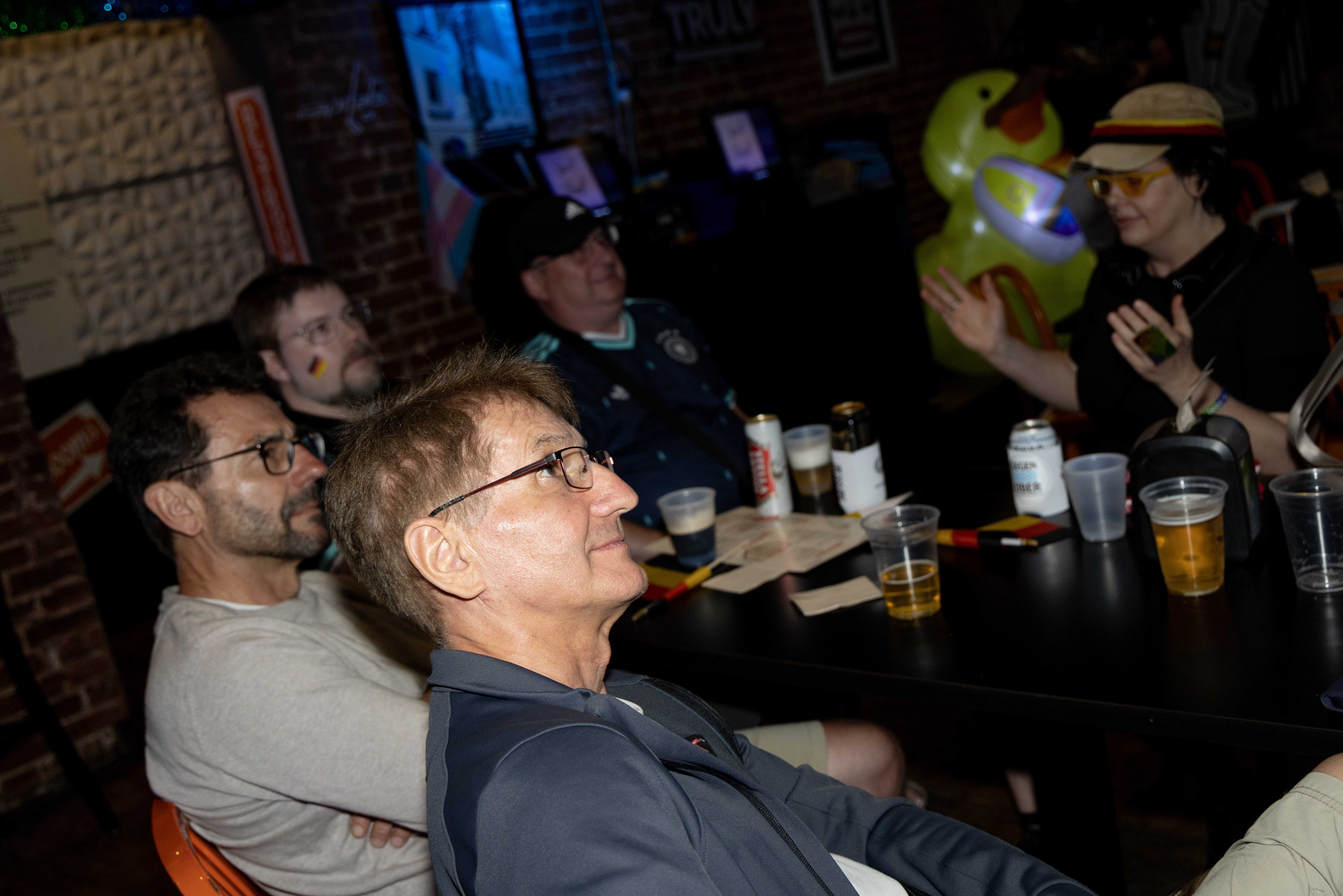 Klaus Steinbrenner, foreground, watches the Germany-Ecuador World Cup match on Thursday with his brother Marcus, to his left, and other German fans Thursday at Pitchers bar in D.C. The thermostat was set at a “sensible 72,” but at least one German wanted it warmer. (Christine Kao/The Washington Post)