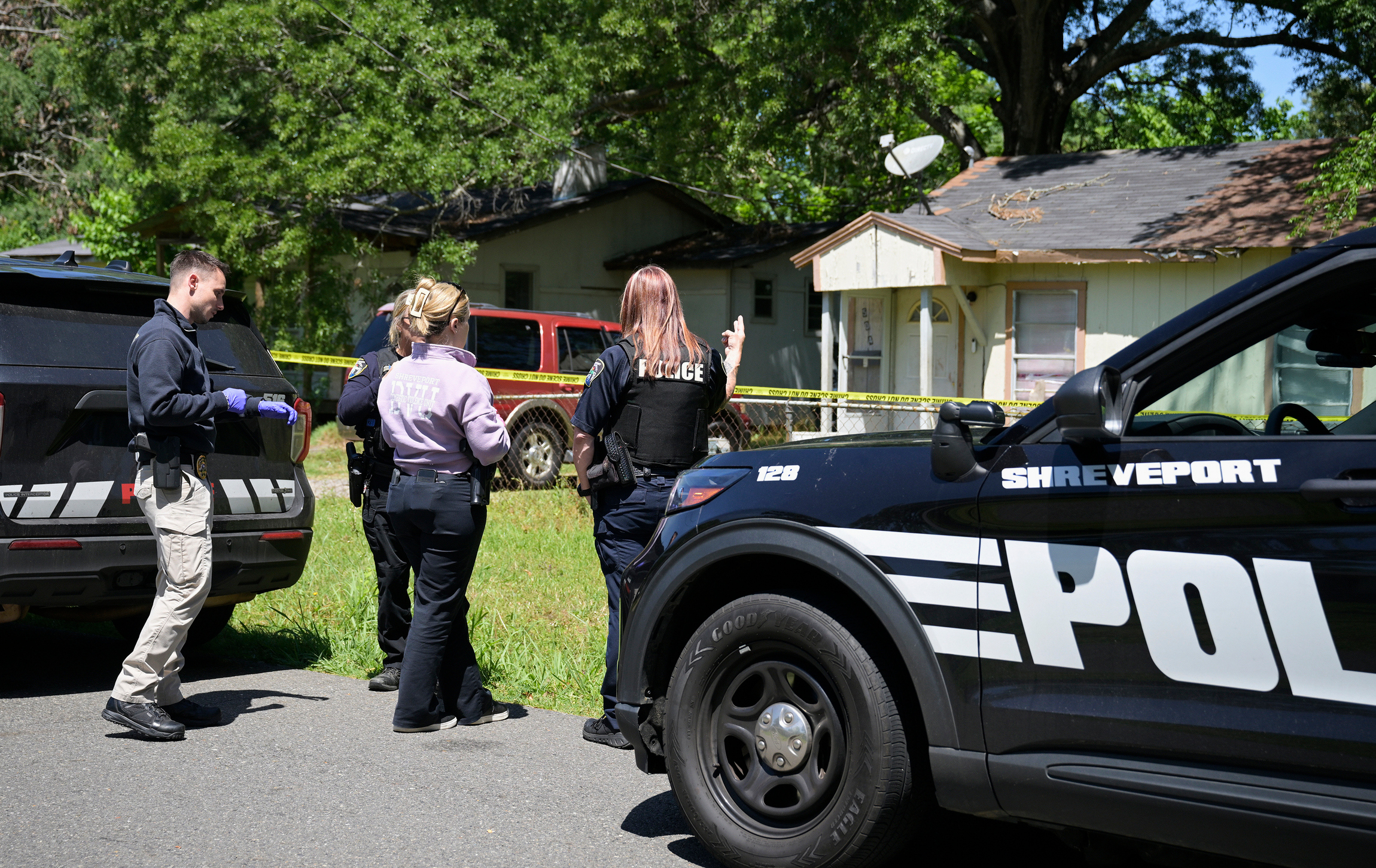 Police gather in front of a house as they investigate Sunday's shooting in Shreveport, Louisiana. (Jill Pickett/AP)