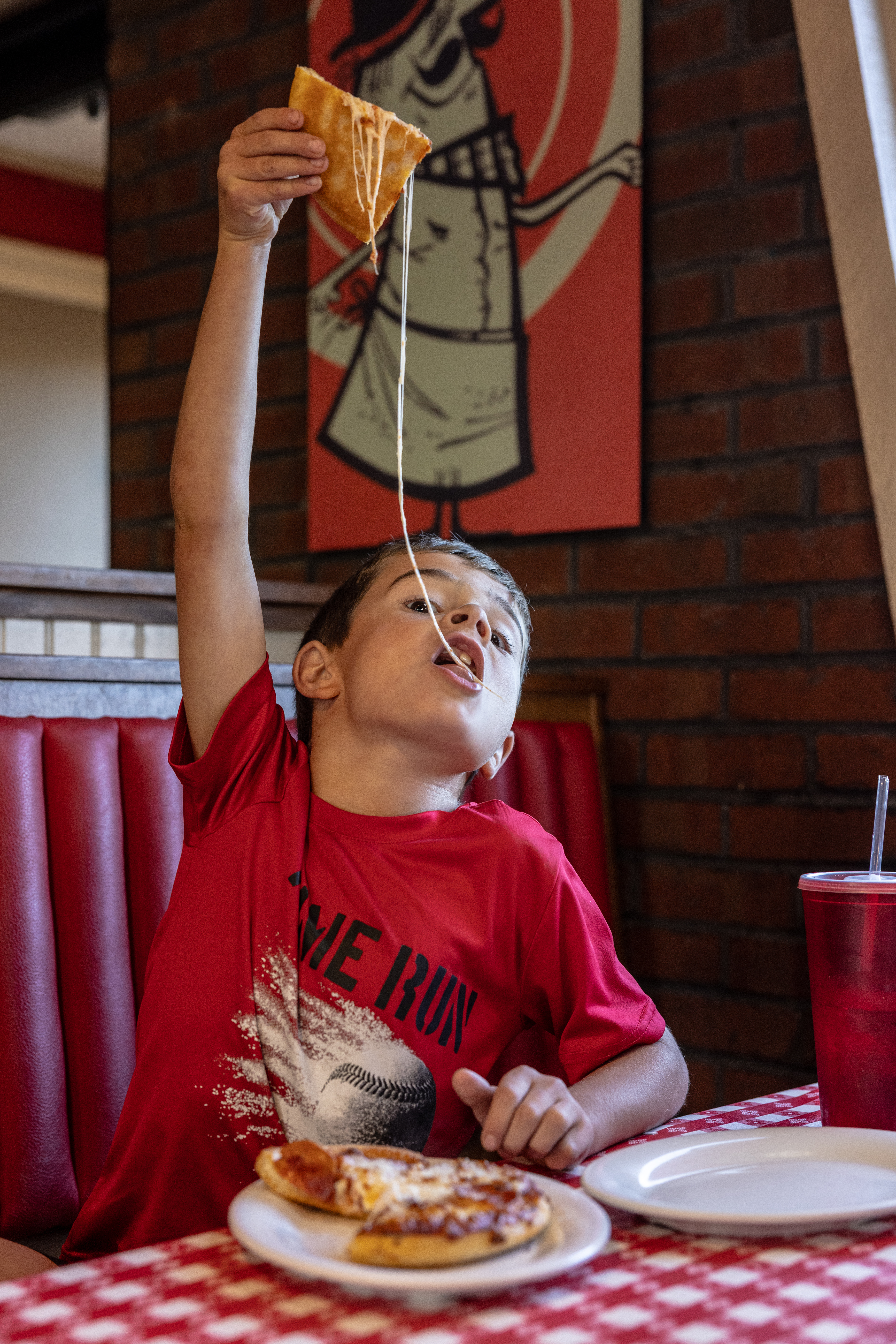 Brooks Burton lifts a piece of his personal pan pizza at a Pizza Hut in Louisa, Virginia. (Parker Michels-Boyce/For The Washington Post)