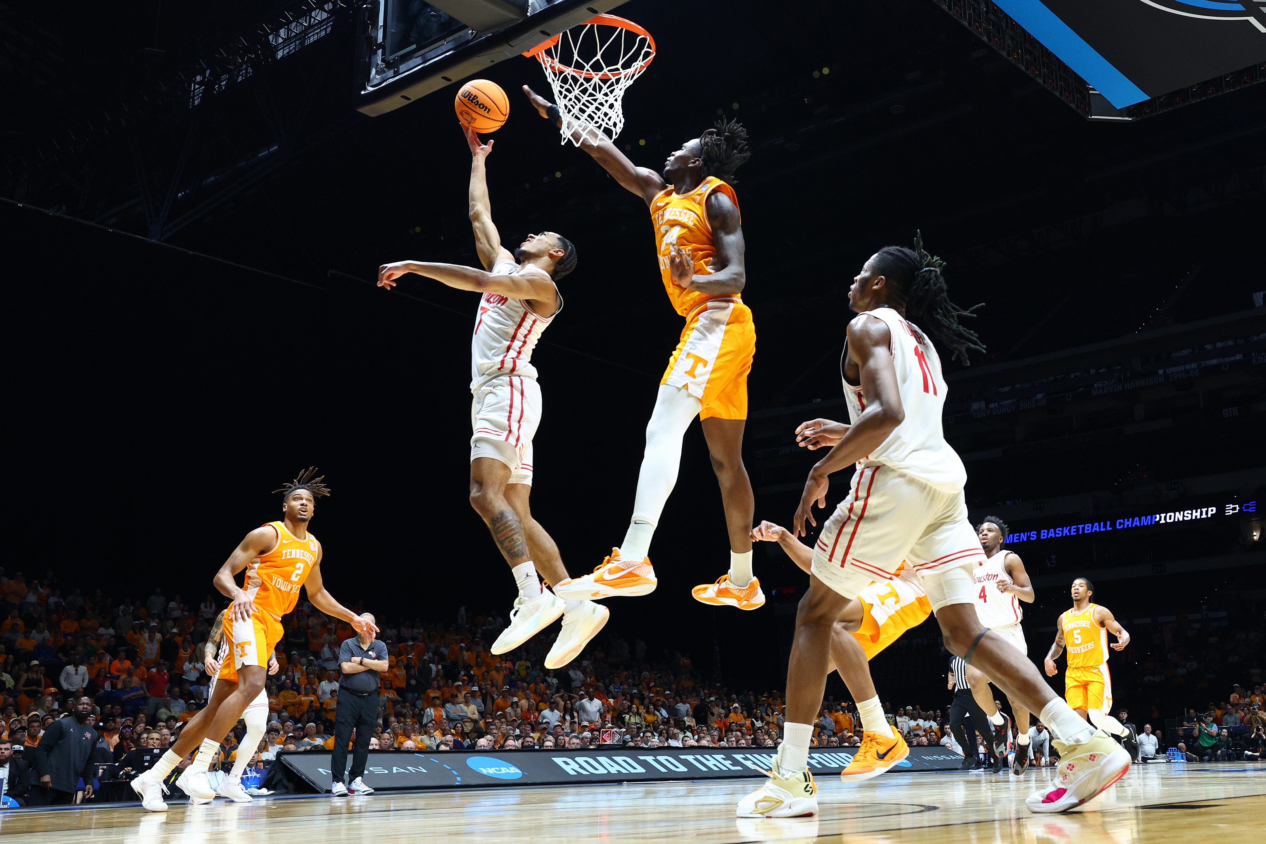 Tennessee's Felix Okpara, third from left, challenges Houston's Milos Uzan in an NCAA tournament game in March. (Andy Lyons/Getty Images)