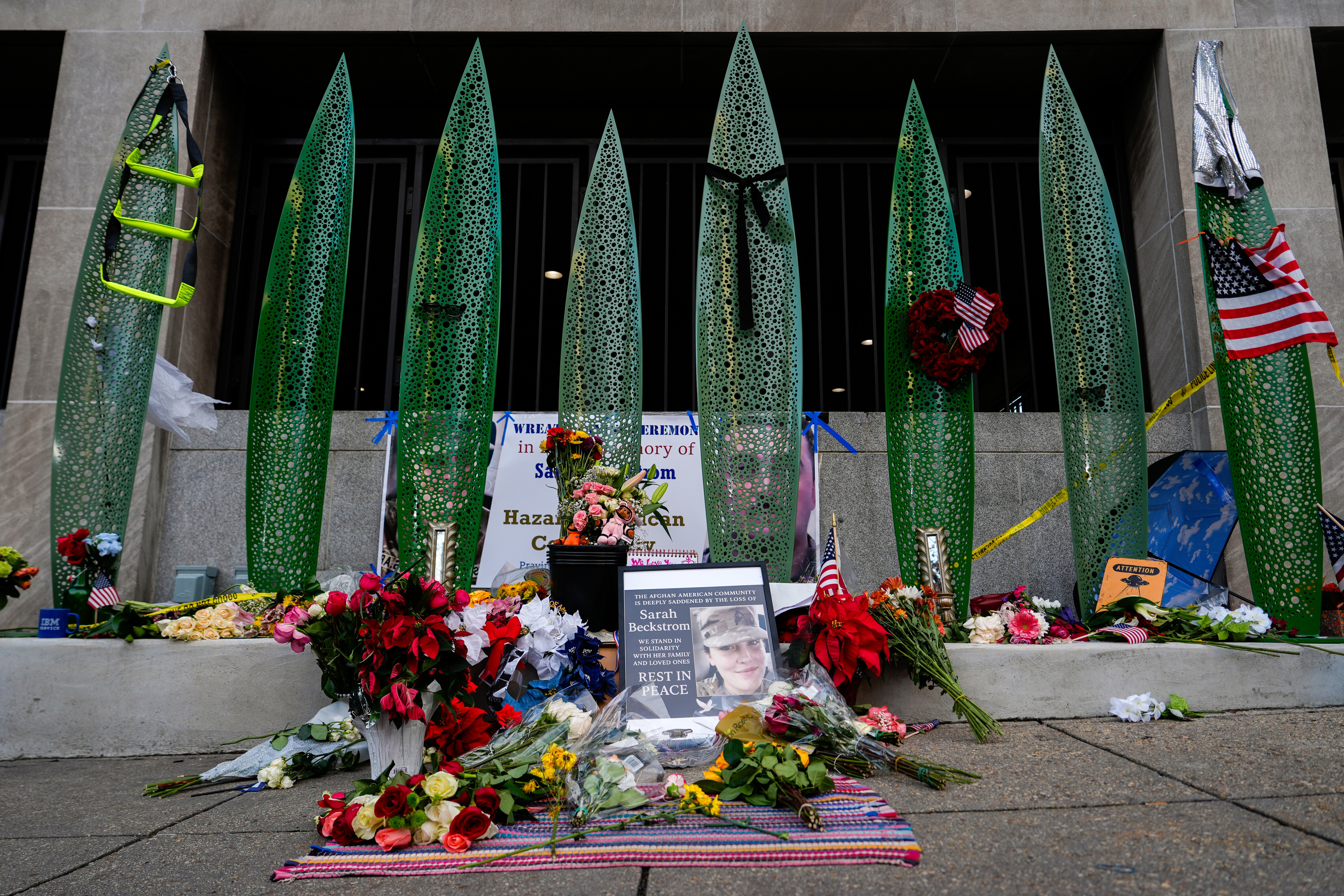 A makeshift memorial for Spec. Sarah Beckstrom and Staff Sgt. Andrew Wolfe is seen last year outside Farragut West station, near where the two were shot in Washington. (Julia Demaree Nikhinson/AP)