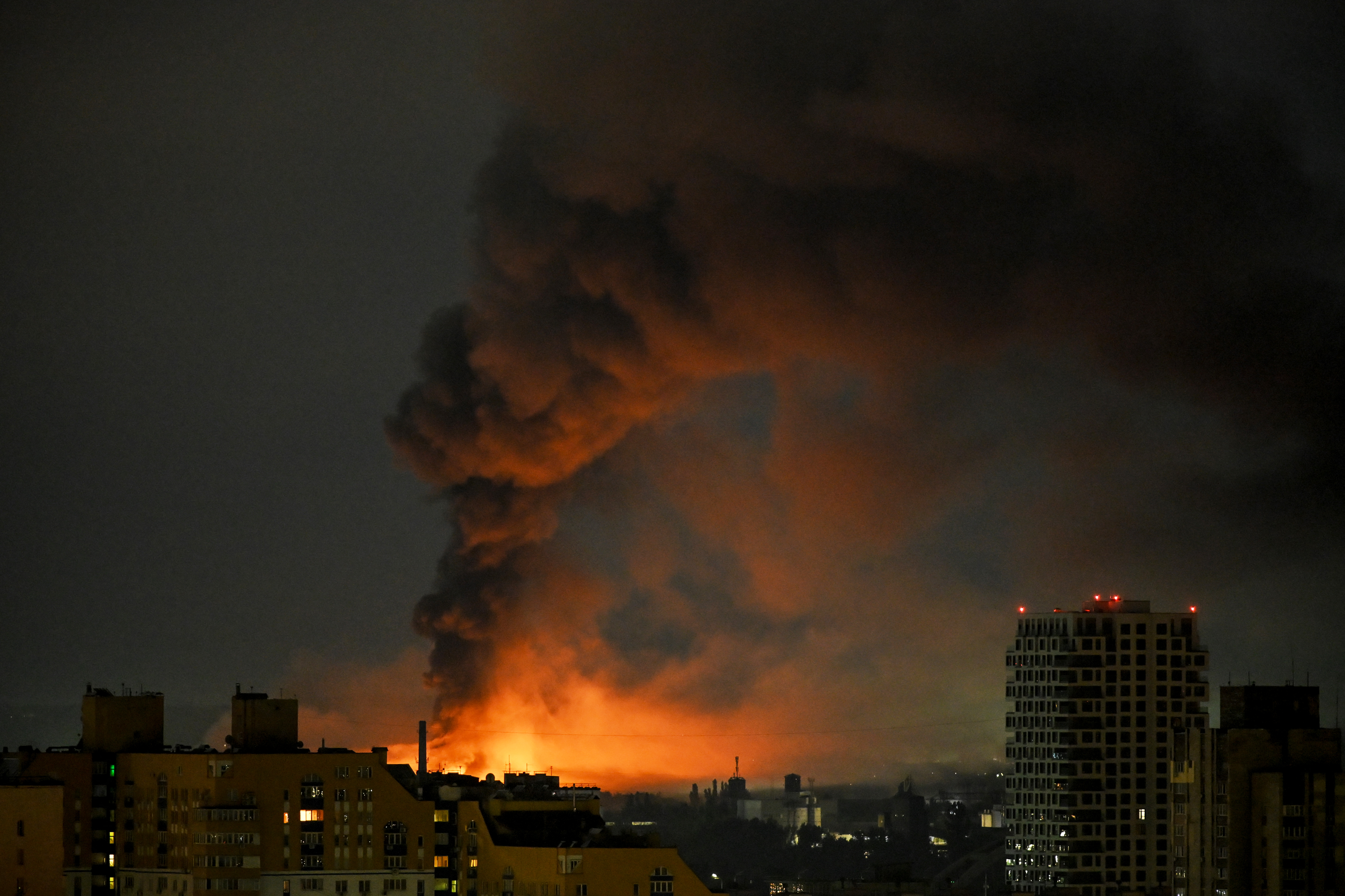 Smoke rises above residential buildings after an air attack in Kyiv on Saturday. (Eugene Kotenko/AFP/Getty Images)