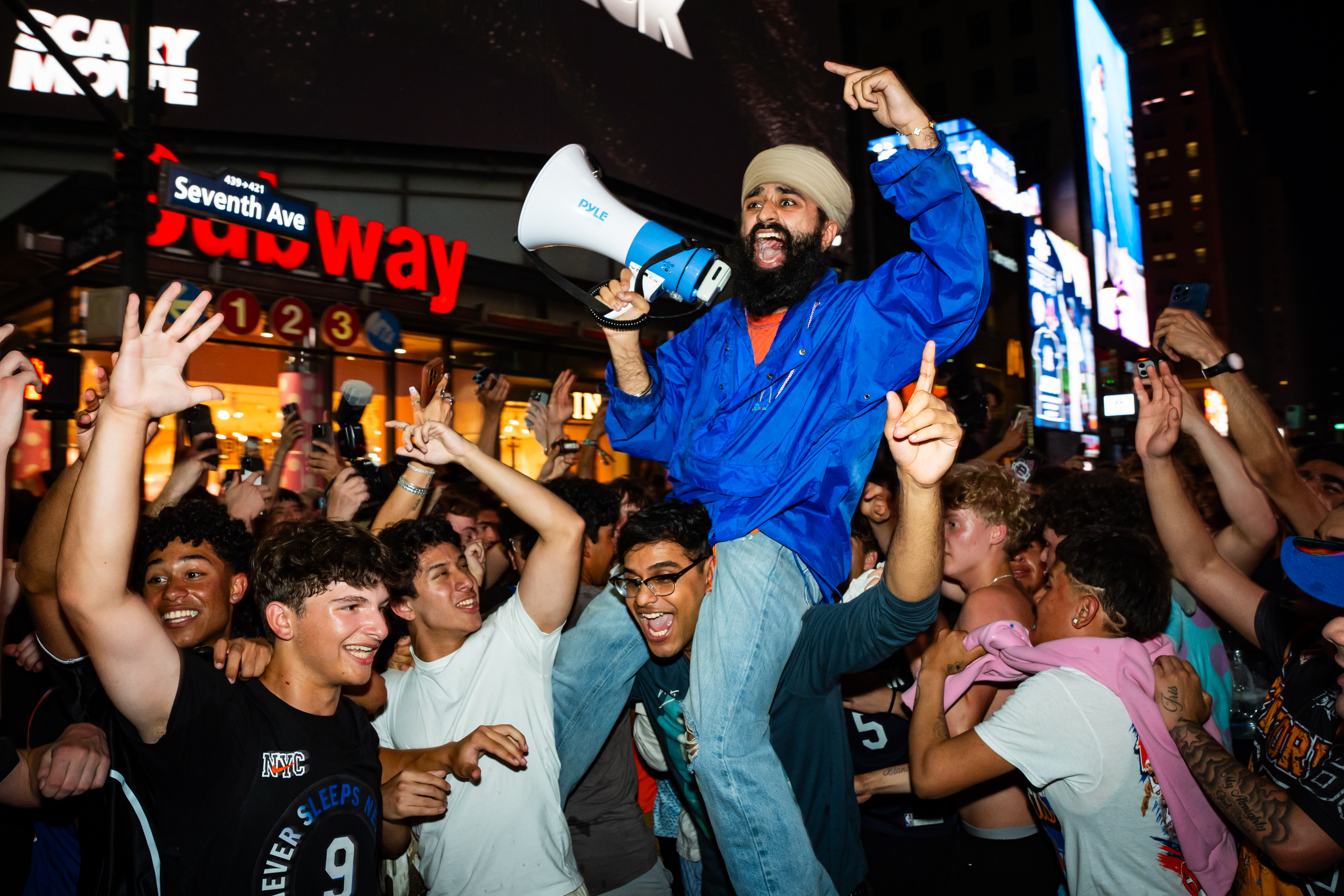 New York Knicks fans celebrate the team's win Friday against the San Antonio Spurs in Game 2 of the NBA Finals outside of Madison Square Garden in New York. (Angelina Katsanis/Getty Images)