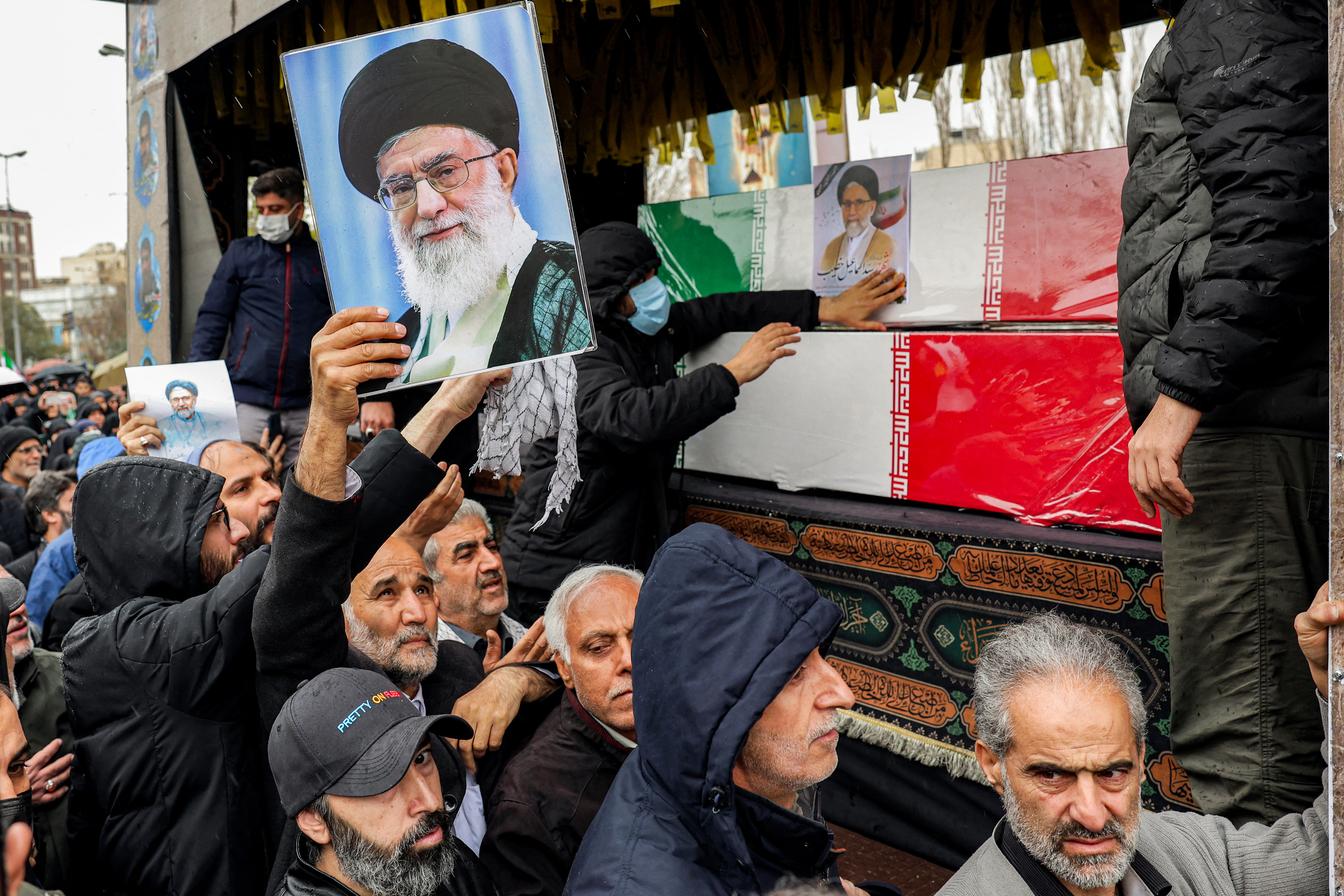 Mourners in Tehran pay their respects during the funeral of Iran’s intelligence minister, Esmail Khatib, and those of his family on Friday. (AFP/Getty Images)