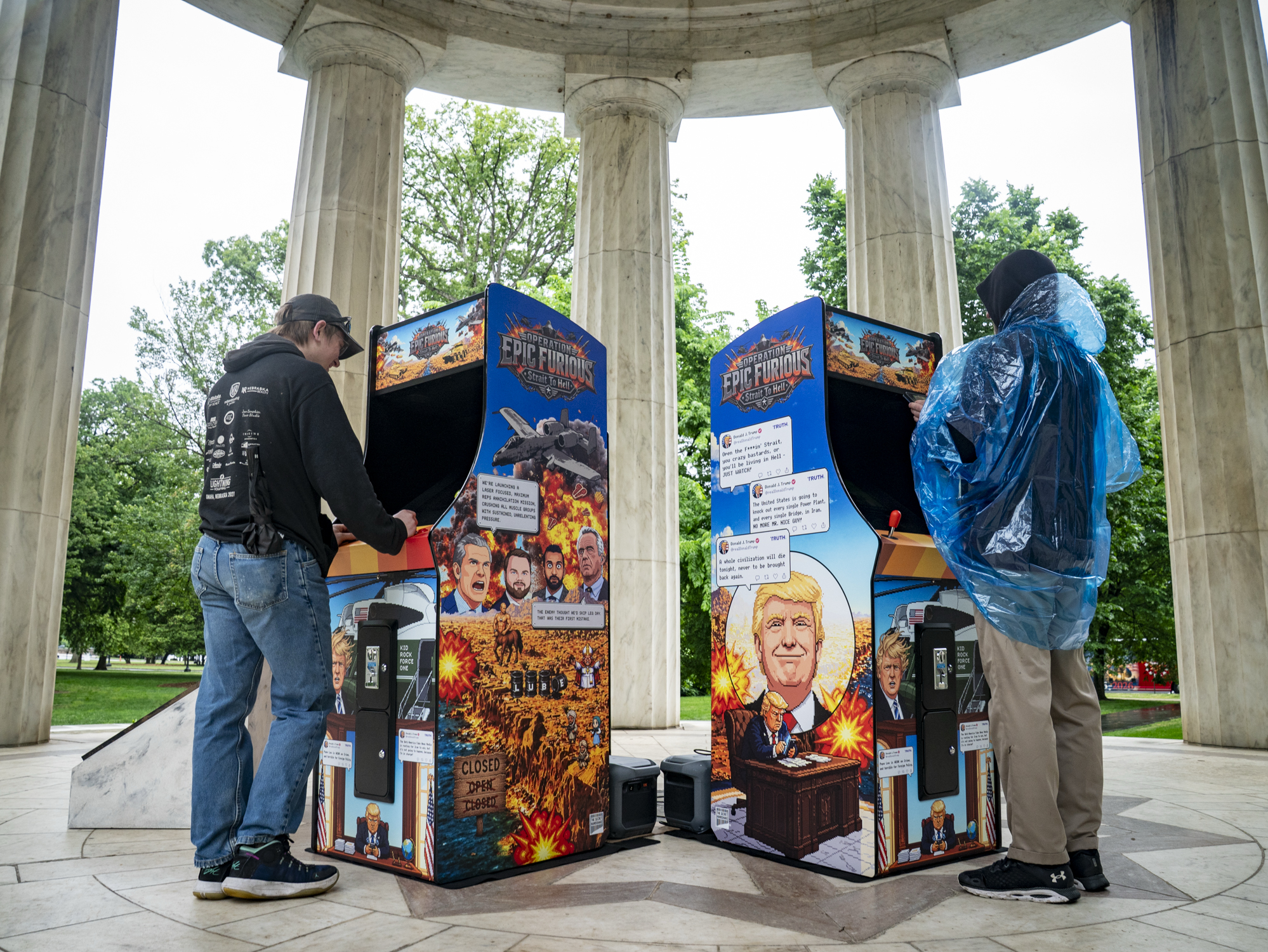 Josh Bengston, left, and Cory Bengston (right) play the new Trump Arcade installation game at the D.C. War Memorial. (Maxine Wallace/The Washington Post)
