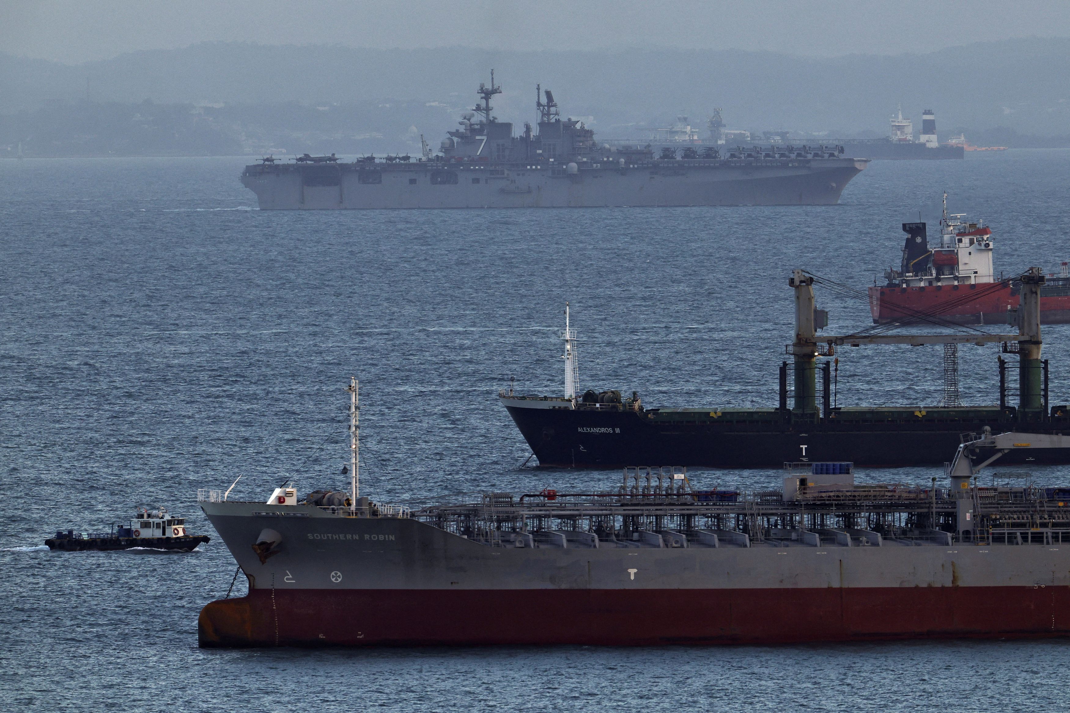 The USS Tripoli amphibious assault ship enters the Singapore Strait, amid the U.S.-Israeli conflict with Iran, on March 17. (Edgar Su/Reuters)