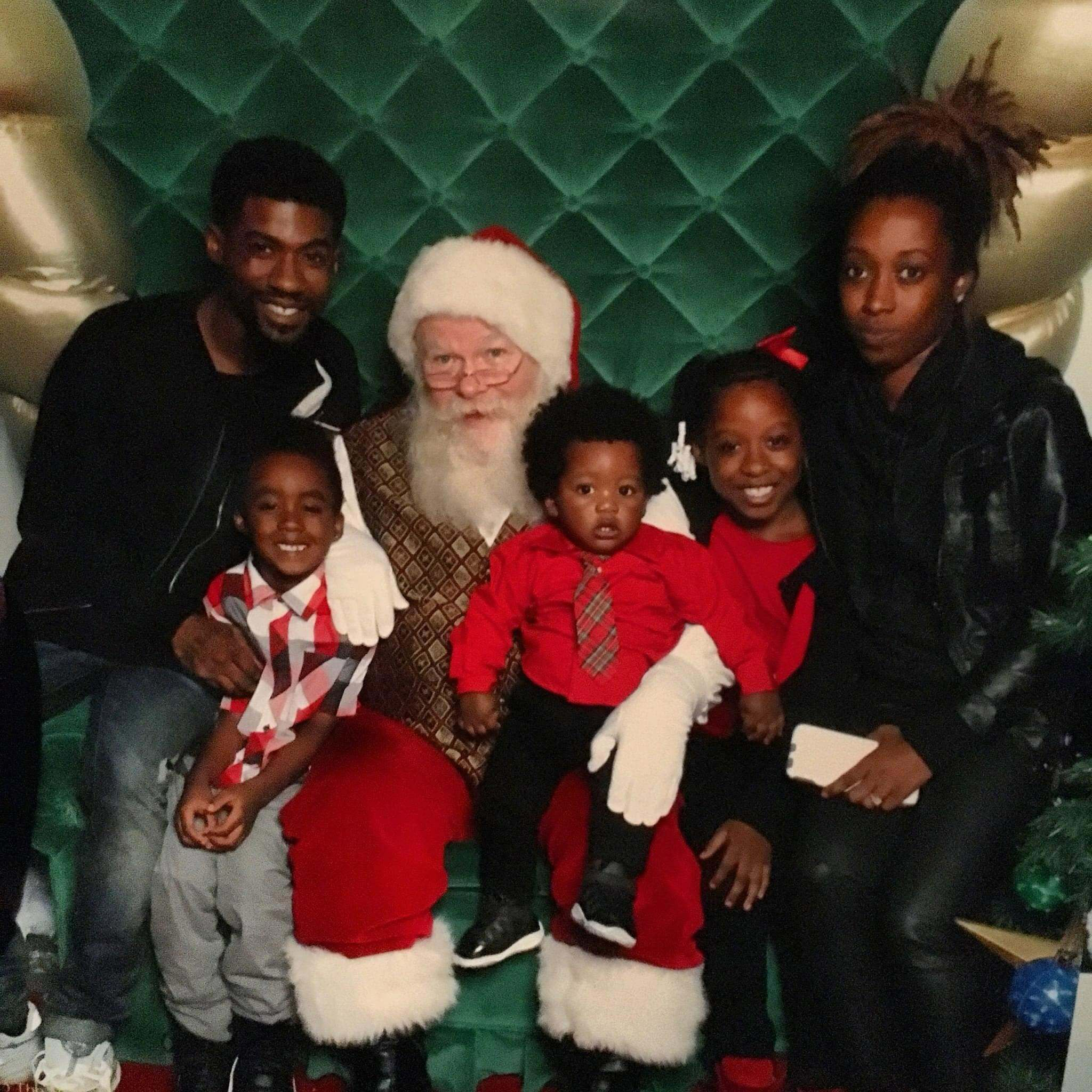 Kevin and Arronna Redd visit Santa with three of their children. Kevin Redd was gunned down by a stranger and left for dead after a brief interaction at a gas station in 2020. (Courtesy Redd family/Redd family)