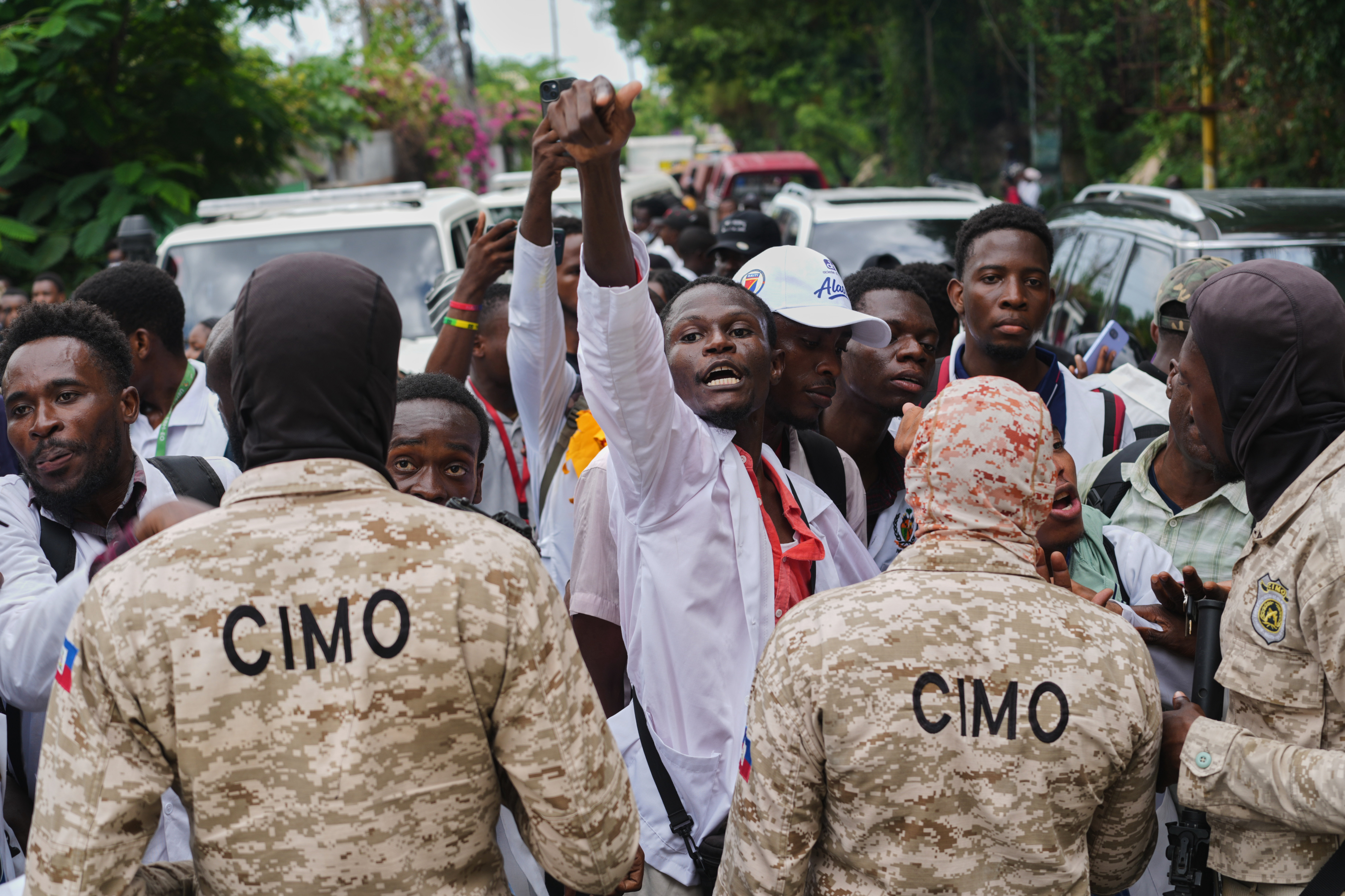 Police officers block medical students from advancing Wednesday during a protest demanding the reopening of the General Hospital in Port-au-Prince, Haiti. (Odelyn Joseph/AP)