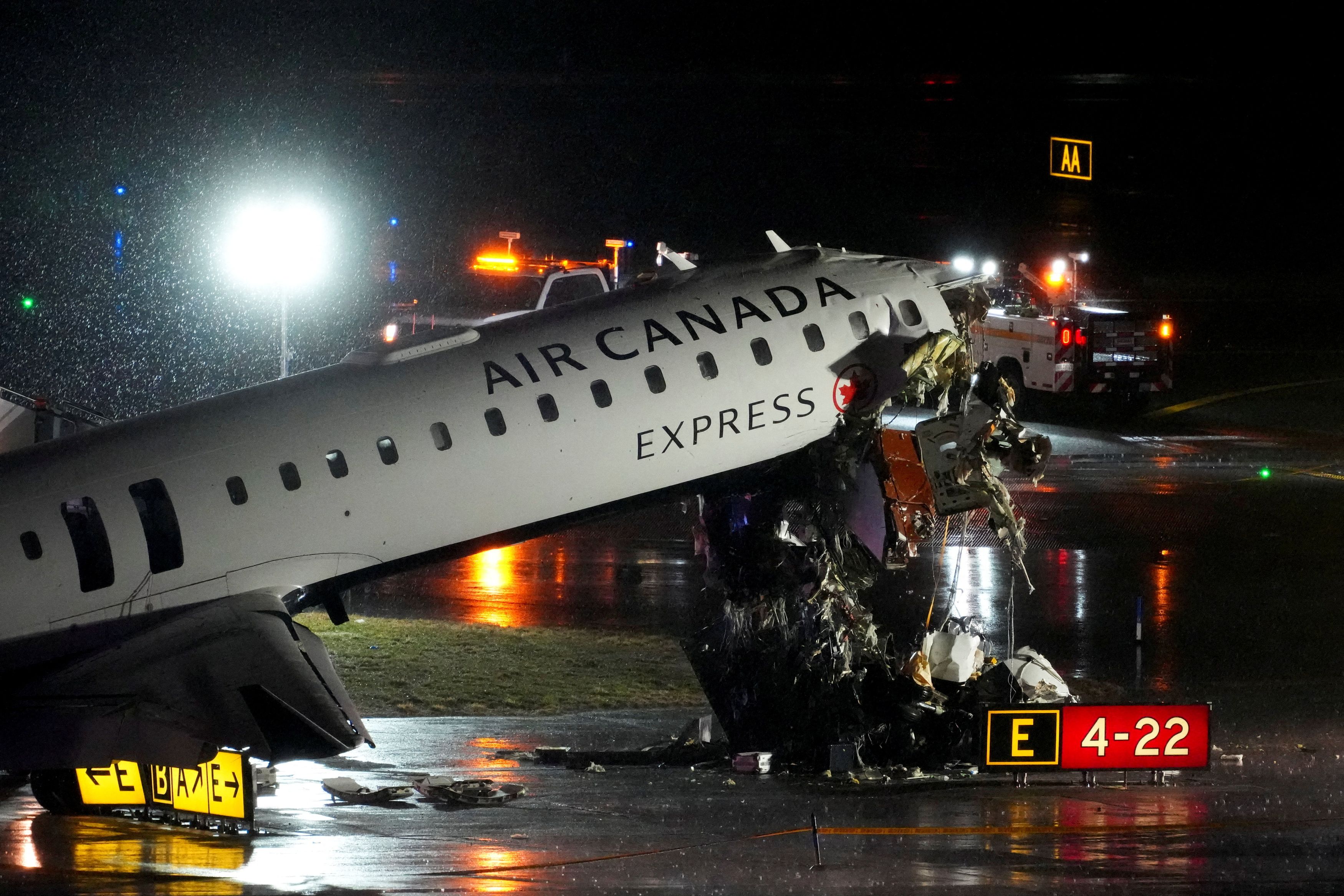Debris hangs from a damaged Air Canada Express jet that struck a fire truck at New York's LaGuardia Airport on Sunday. (Adam Gray/Reuters)
